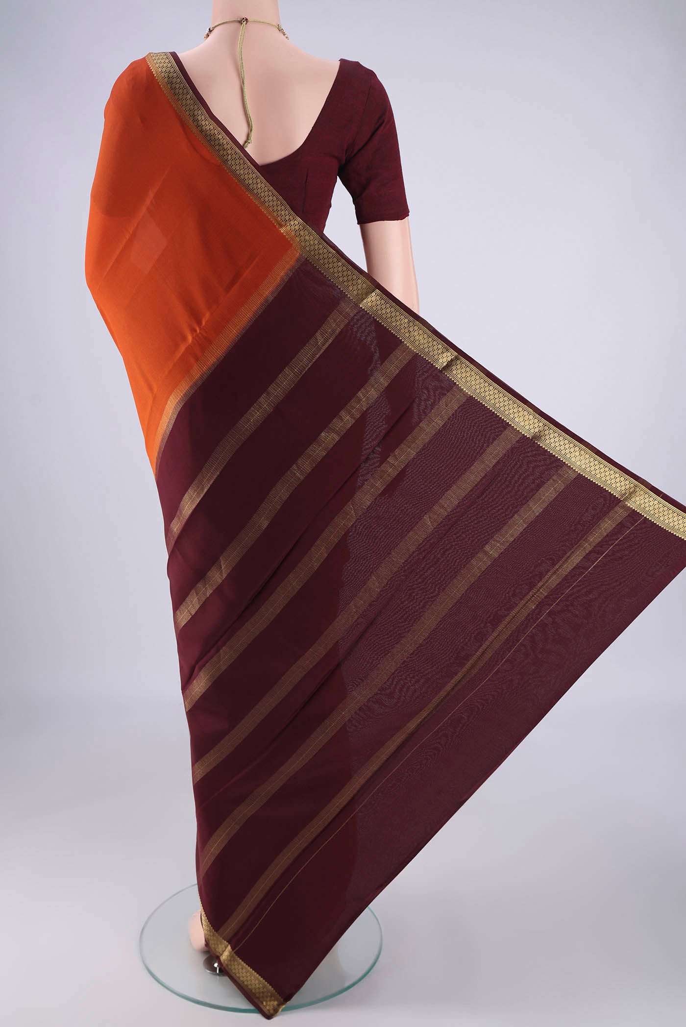 Flat view of Rust Mysore Crepe Saree with Plain Body and Zari Border. 