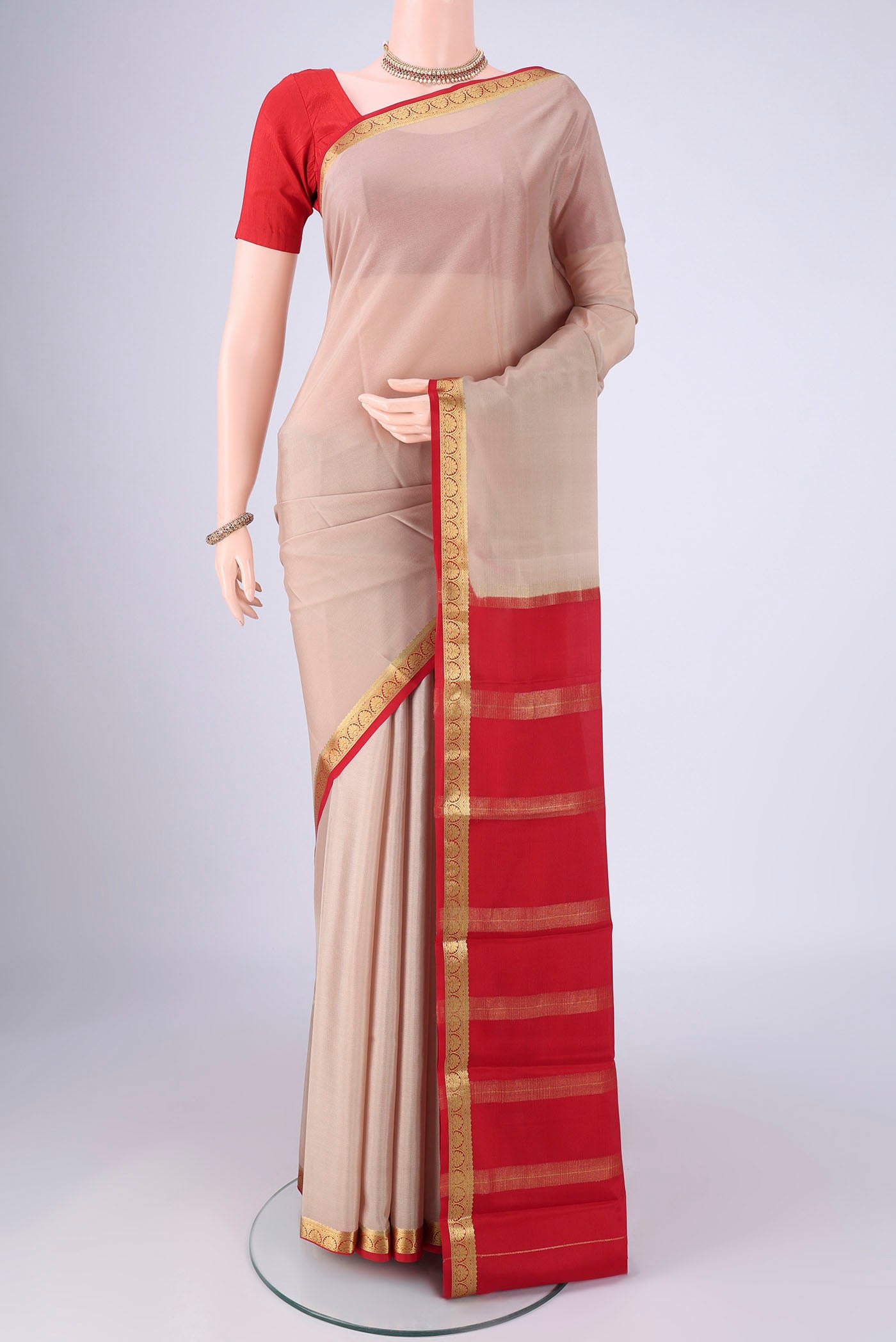 Beige Mysore Crepe Saree with Plain Body and Zari Border.  displayed on a mannequin