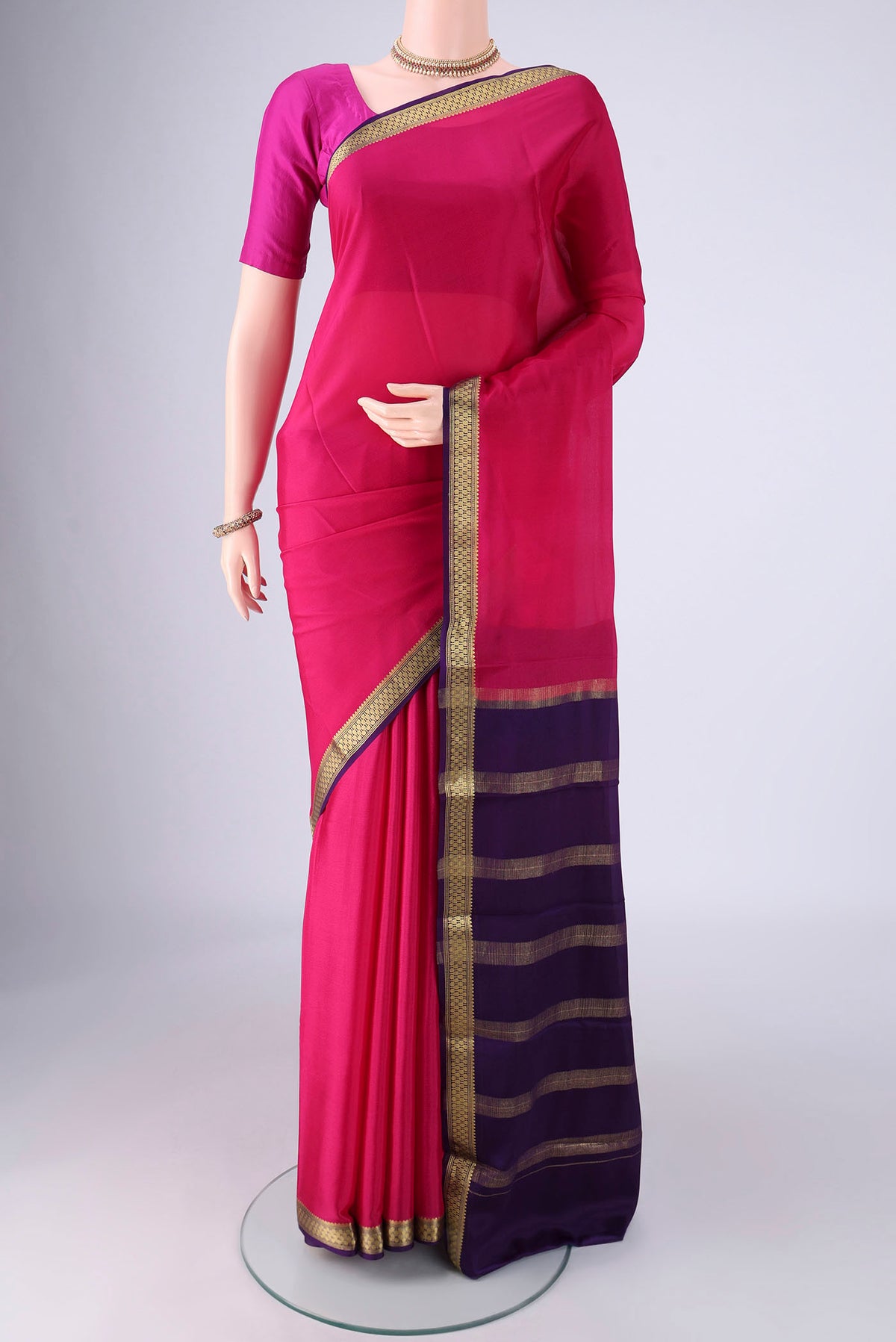 Rani Pink Mysore Crepe Saree with Plain Body and Zari Border.  displayed on a mannequin