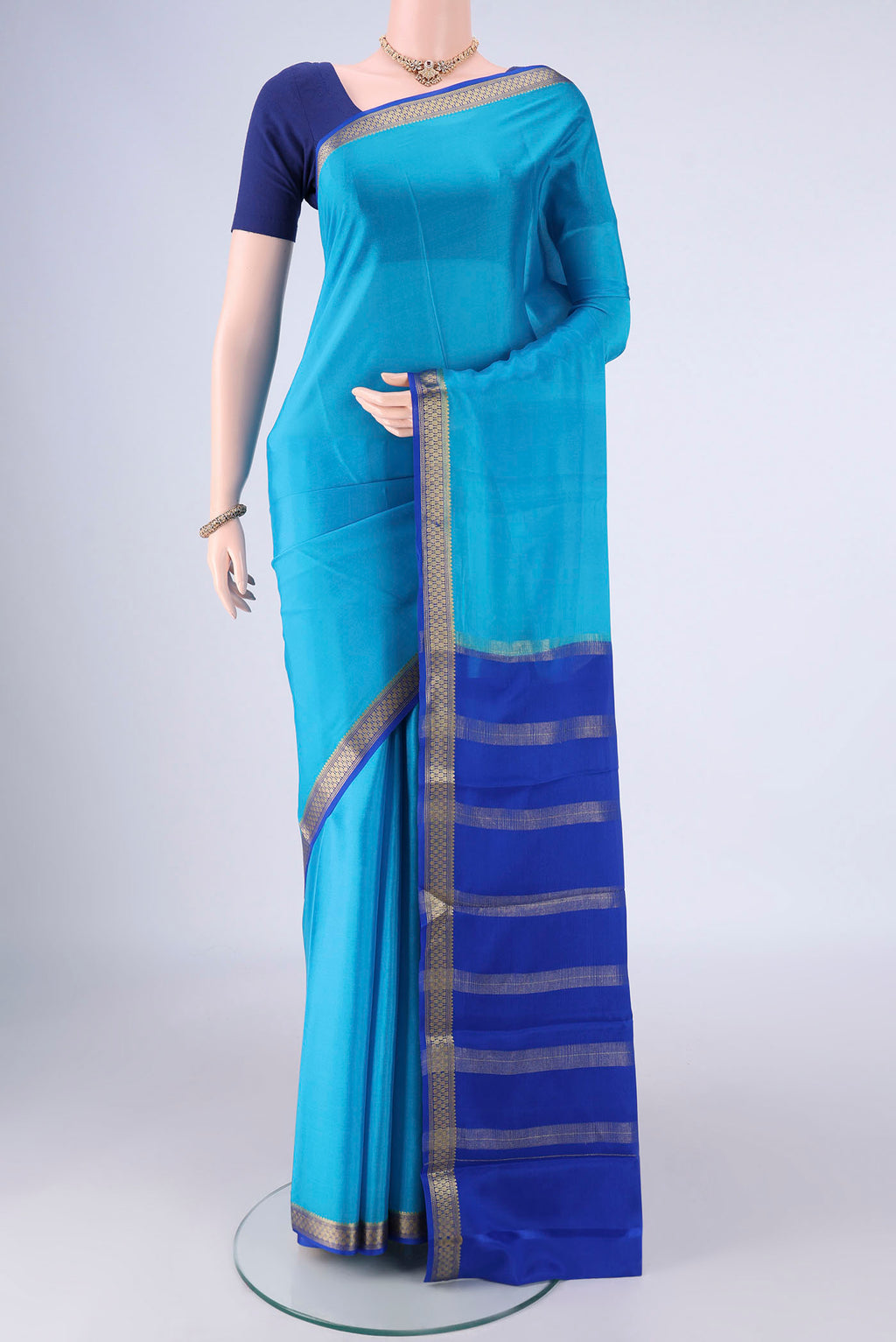 Blue Mysore Crepe Saree with Plain Body and Zari Border.  displayed on a mannequin
