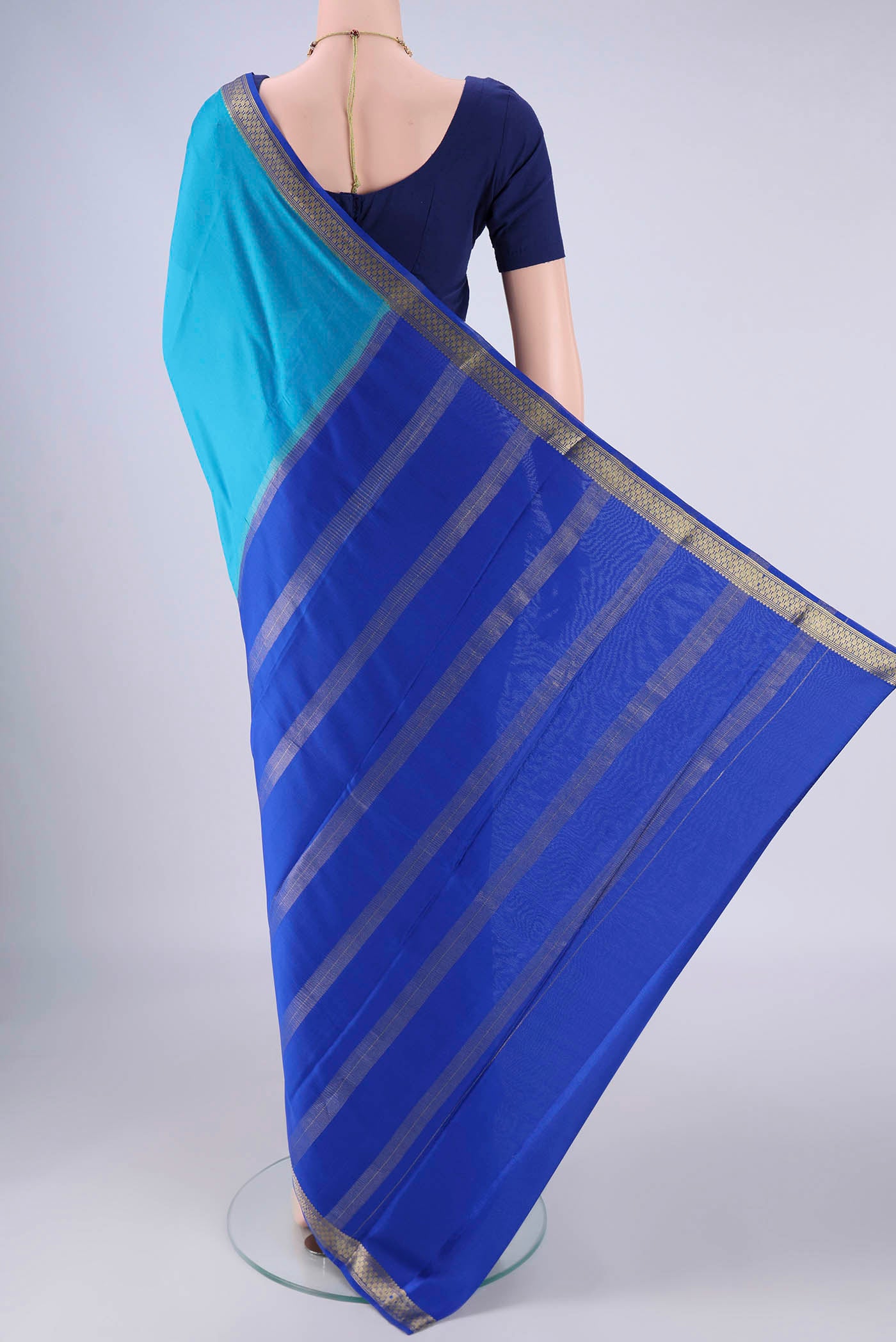 Flat view of Blue Mysore Crepe Saree with Plain Body and Zari Border. 
