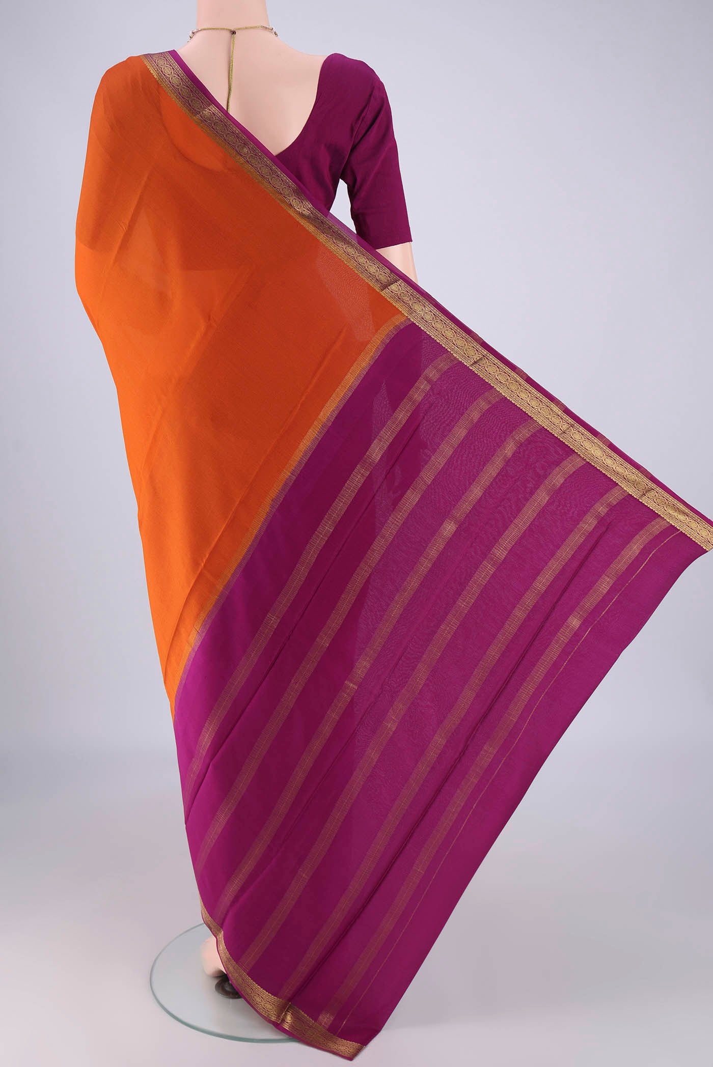 Flat view of Orange Mysore Crepe Saree with Plain Body and Zari Border. 