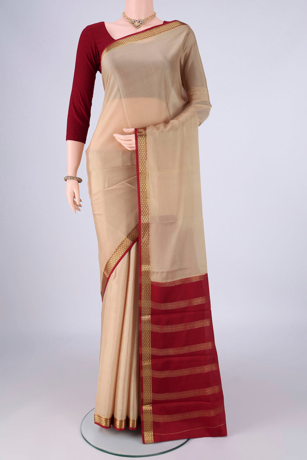 Beige Mysore Crepe Saree with Plain Body and Zari Border.  displayed on a mannequin