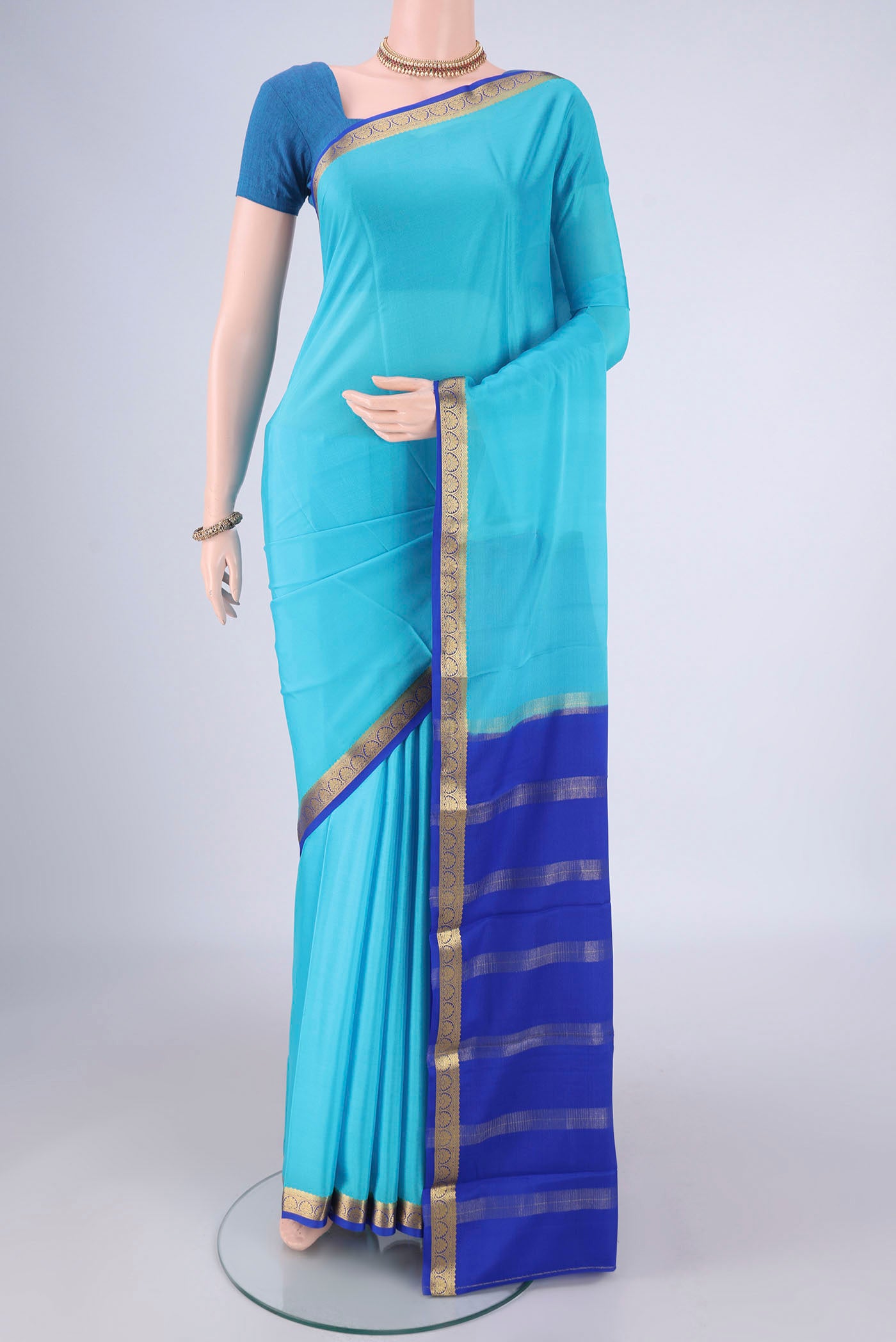 Sky Blue Mysore Crepe Saree with Plain Body and Zari Border.  displayed on a mannequin