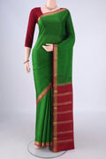 Green Mysore Crepe Saree with Plain Body and Zari Border.  displayed on a mannequin