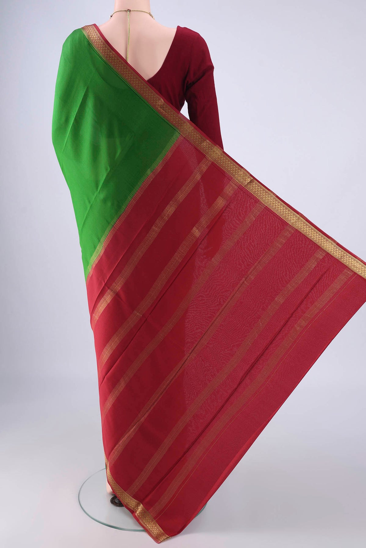 Flat view of Green Mysore Crepe Saree with Plain Body and Zari Border. 