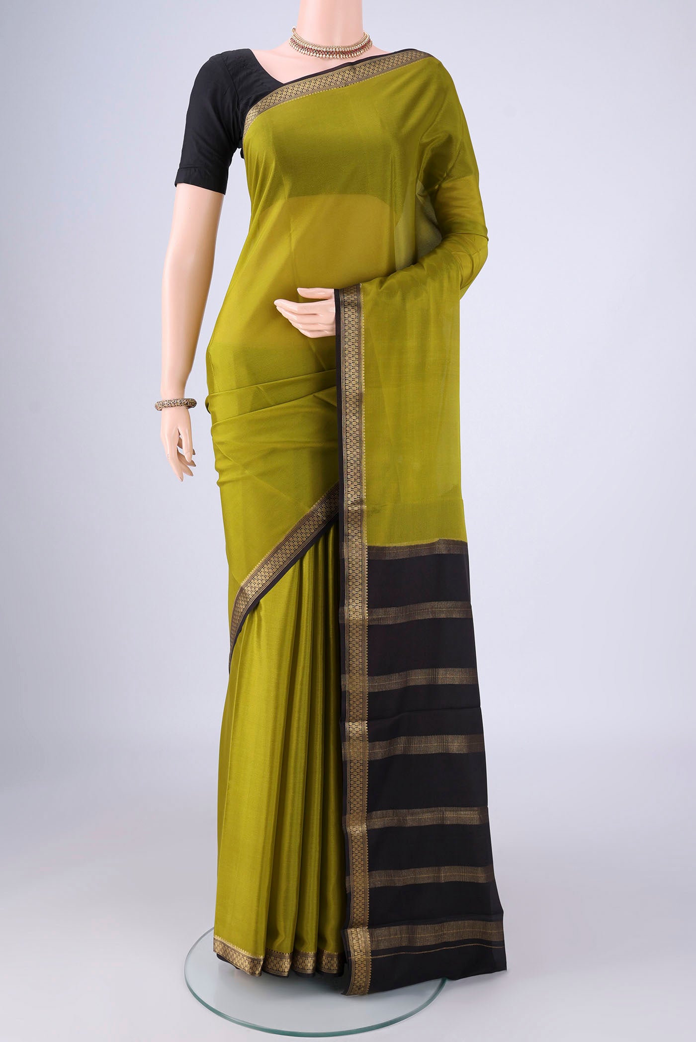 Mehandi Green Mysore Crepe Saree with Plain Body and Zari Border.  displayed on a mannequin