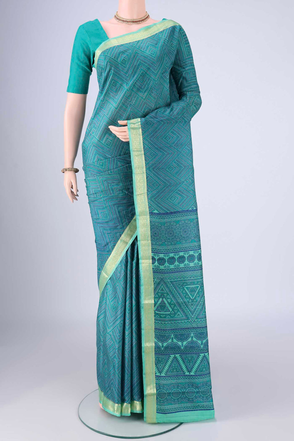 Sea Green Printed Silk Saree with Printed design on the body and Zari Border.  displayed on a mannequin