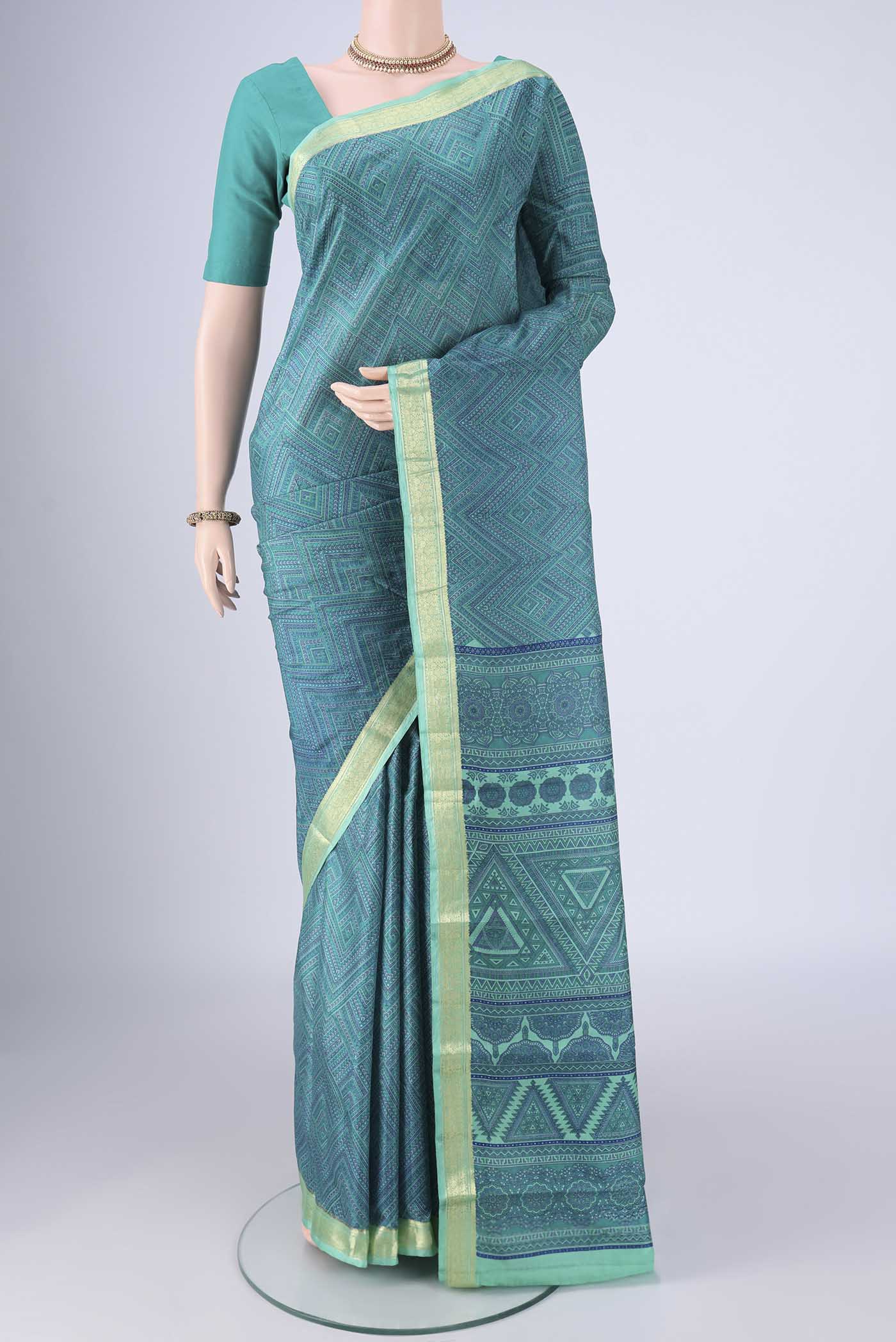 Sea Green Printed Silk Saree with Printed design on the body and Zari Border.  displayed on a mannequin