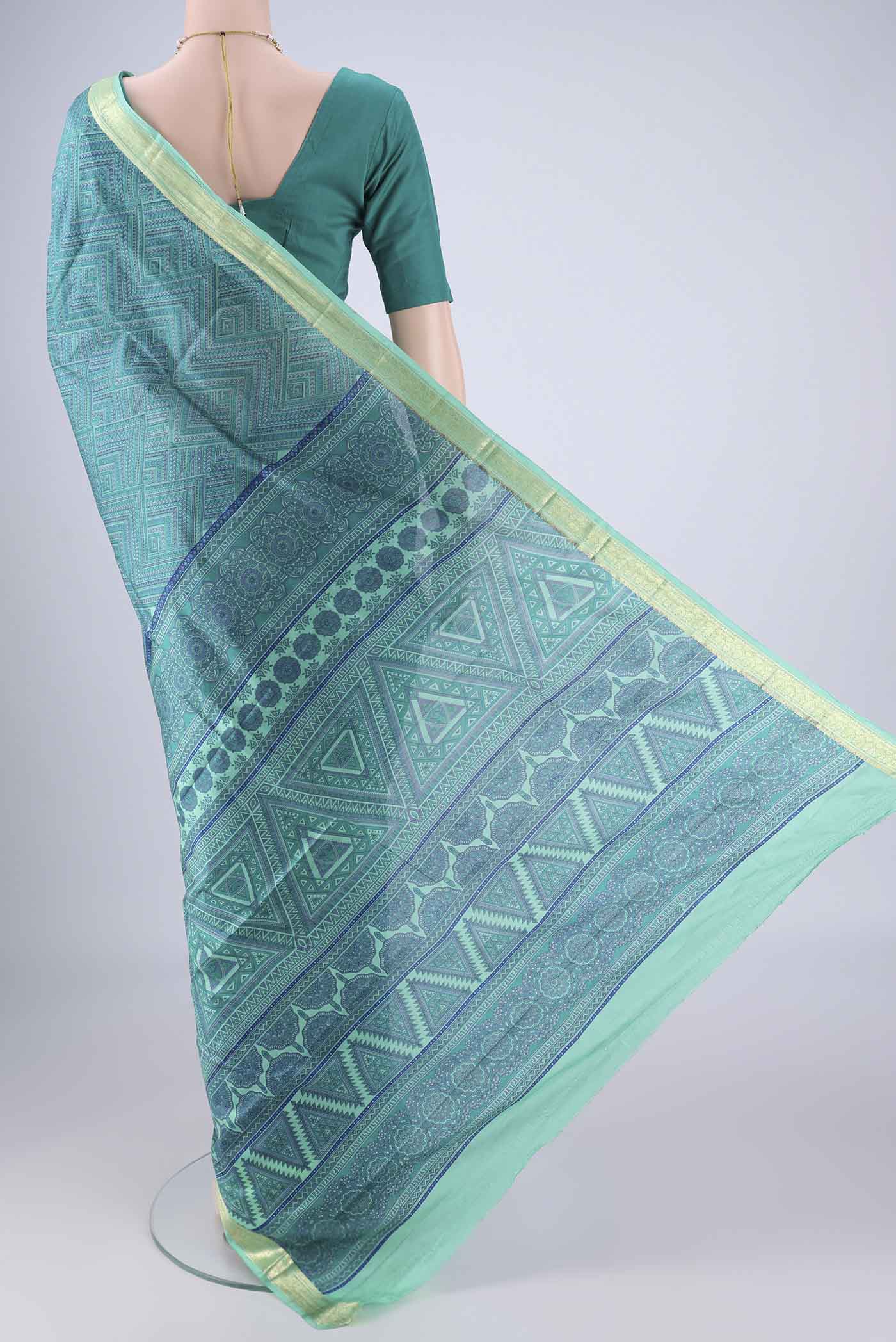 Flat view of Sea Green Printed Silk Saree with Printed design on the body and Zari Border. 