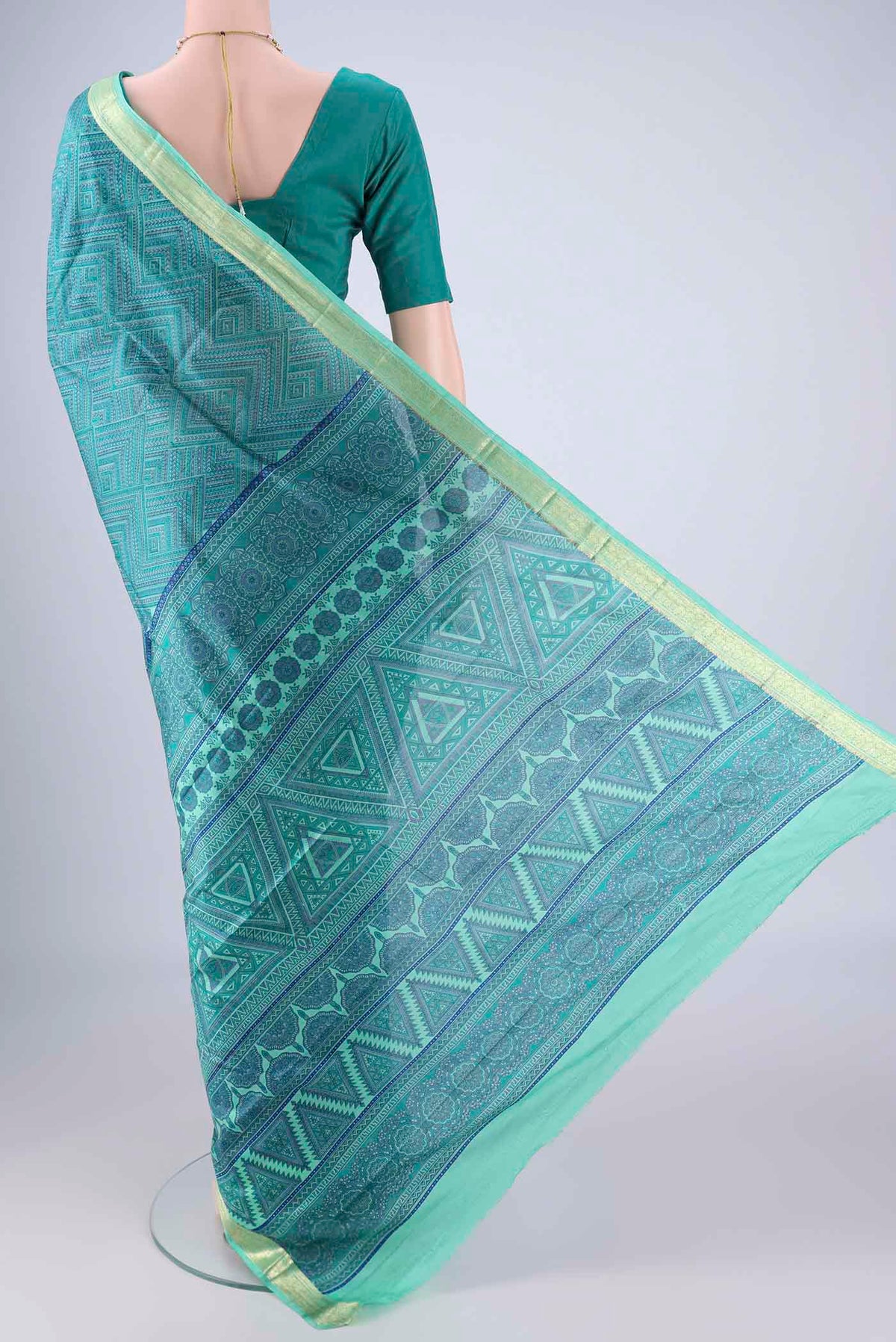 Flat view of Sea Green Printed Silk Saree with Printed design on the body and Zari Border. 
