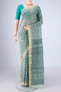 Sage Green Printed Silk Saree with Printed design on the body and Zari Border.  displayed on a mannequin