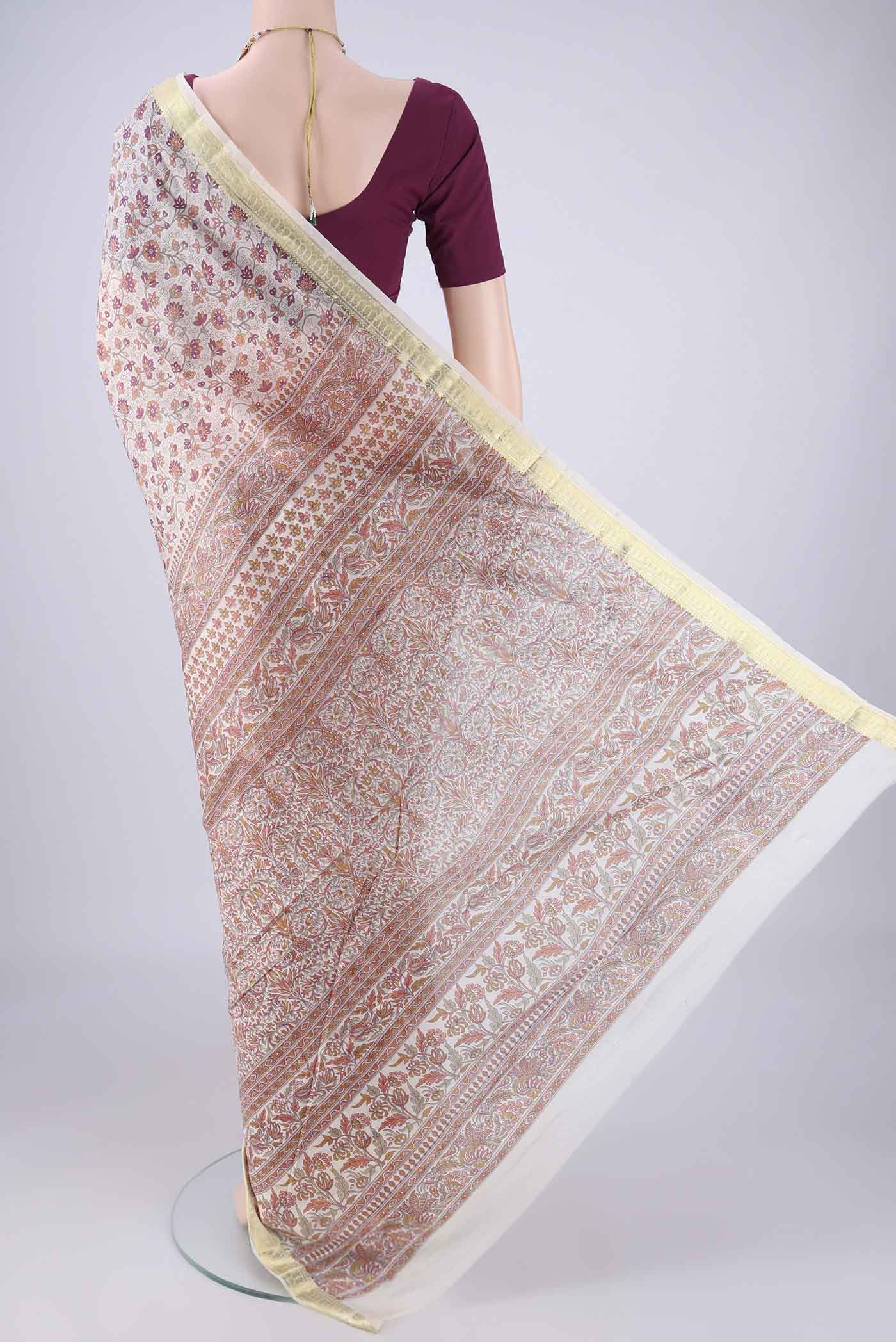 Flat view of Off White Printed Silk Saree with Printed design on the body and Zari Border. 