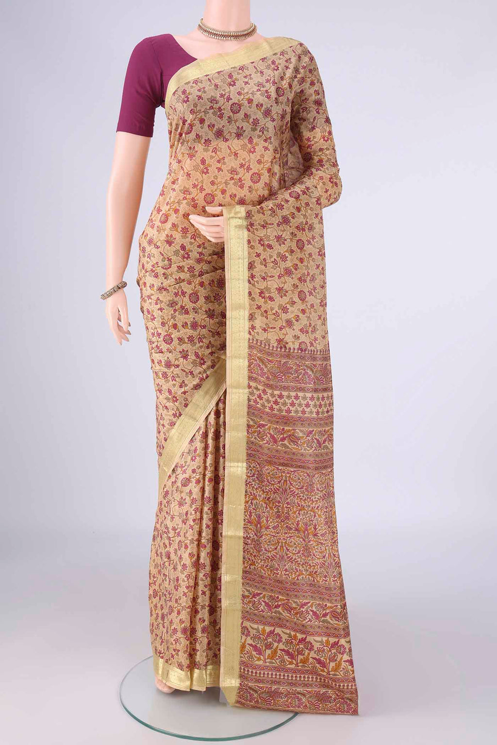 Beige Printed Silk Saree with Printed design on the body and Zari Border.  displayed on a mannequin