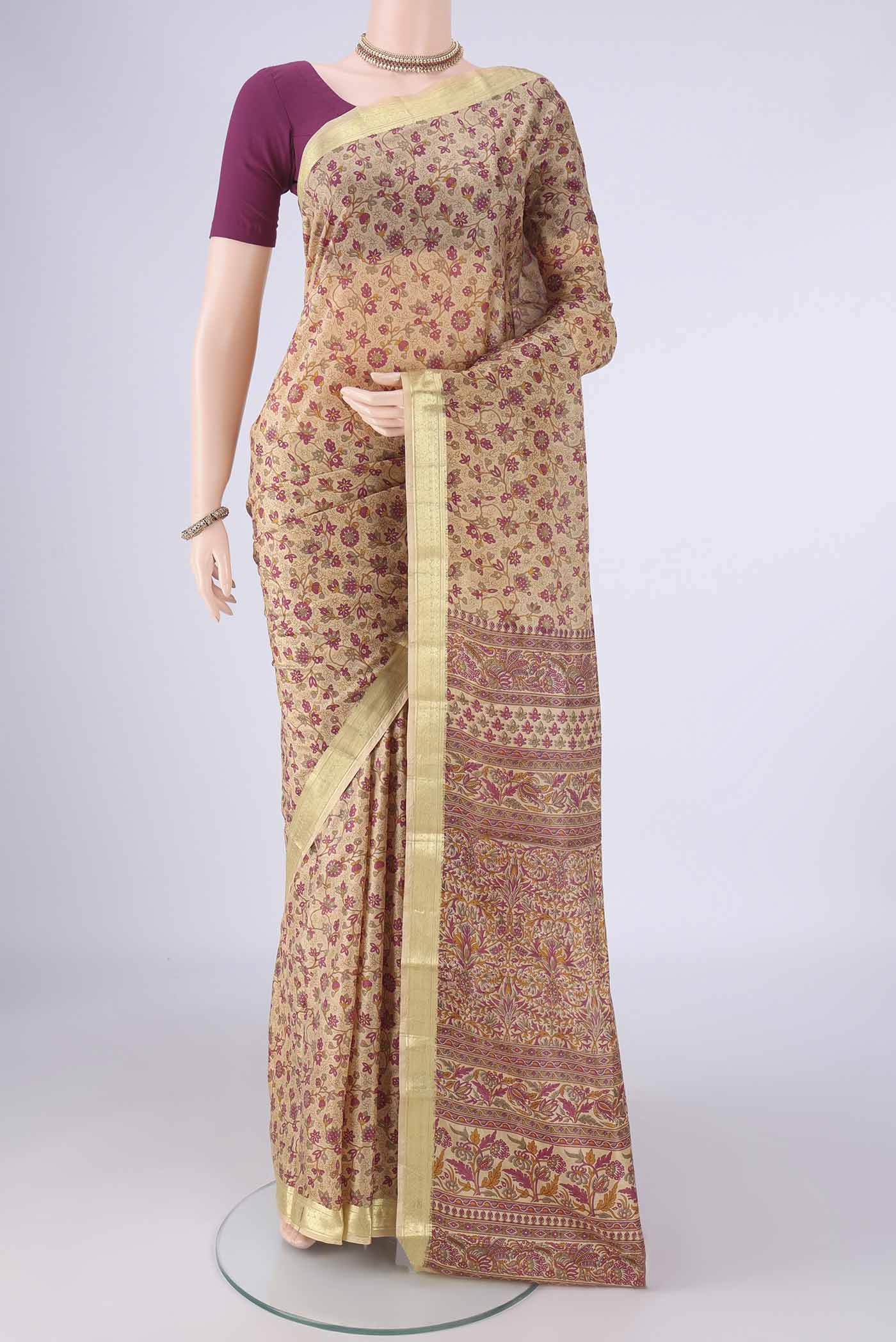 Beige Printed Silk Saree with Printed design on the body and Zari Border.  displayed on a mannequin