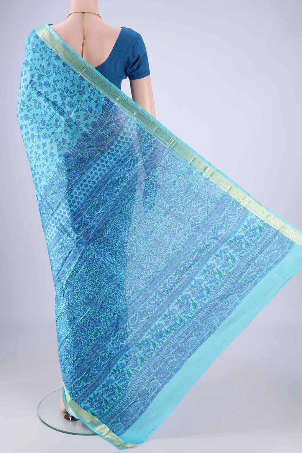 Flat view of Blue Printed Silk Saree with Printed design on the body and Zari Border. 