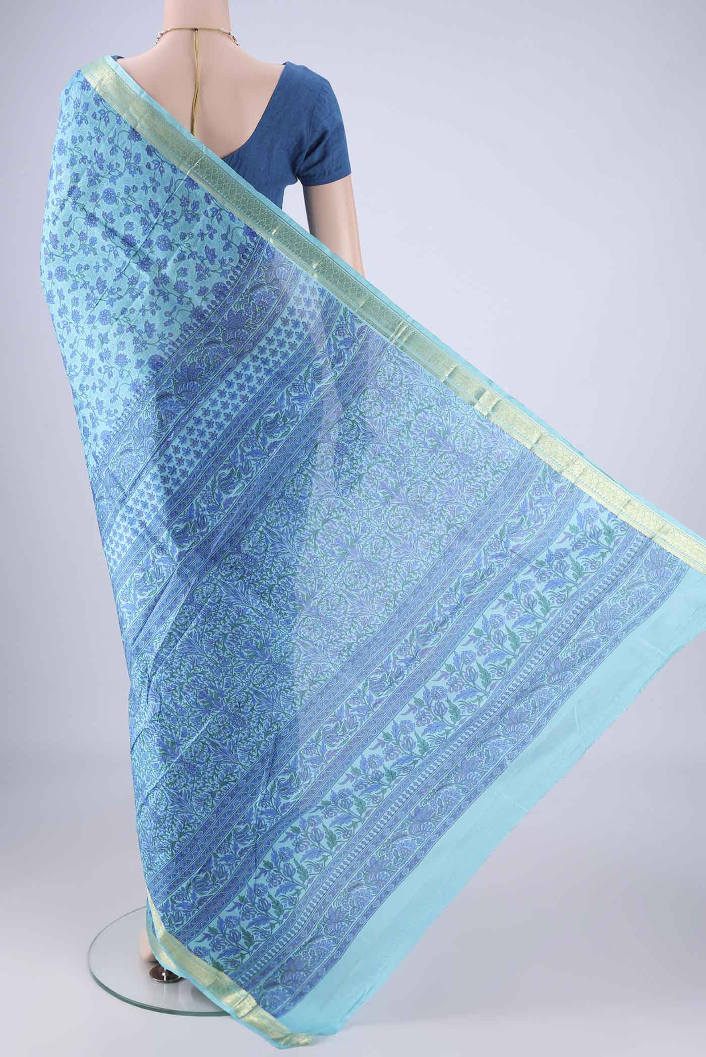 Flat view of Blue Printed Silk Saree with Printed design on the body and Zari Border. 