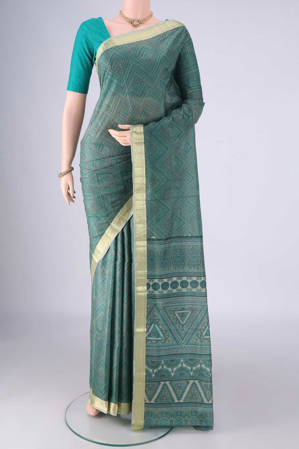 Sea Green Printed Silk Saree with Printed design on the body and Printed Border.  displayed on a mannequin