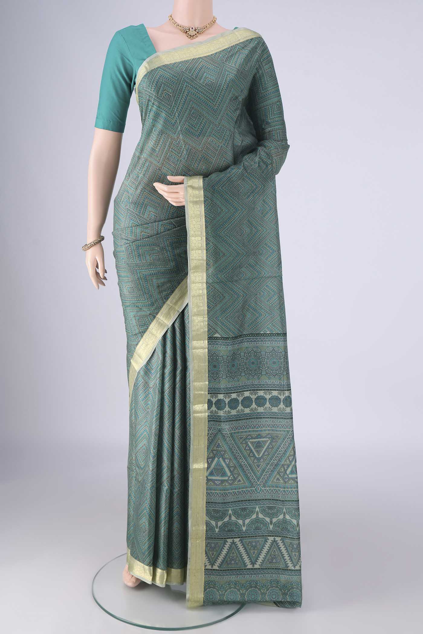 Sea Green Printed Silk Saree with Printed design on the body and Printed Border.  displayed on a mannequin