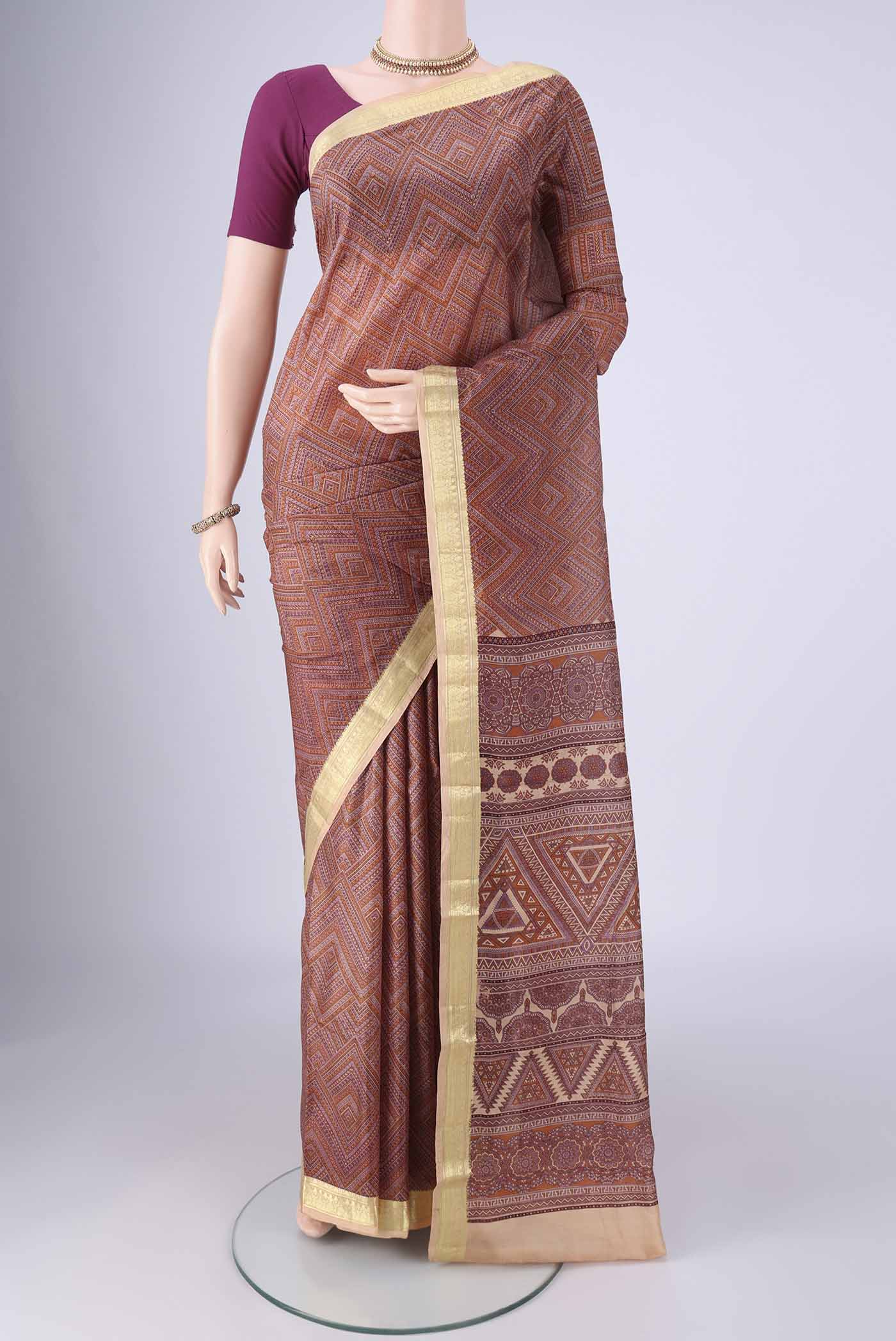Brown Printed Silk Saree with Printed design on the body and Zari Border.  displayed on a mannequin