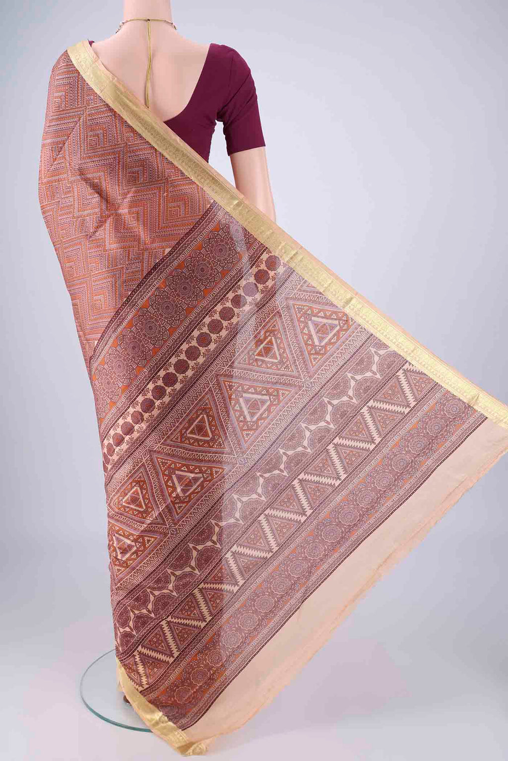 Flat view of Brown Printed Silk Saree with Printed design on the body and Zari Border. 