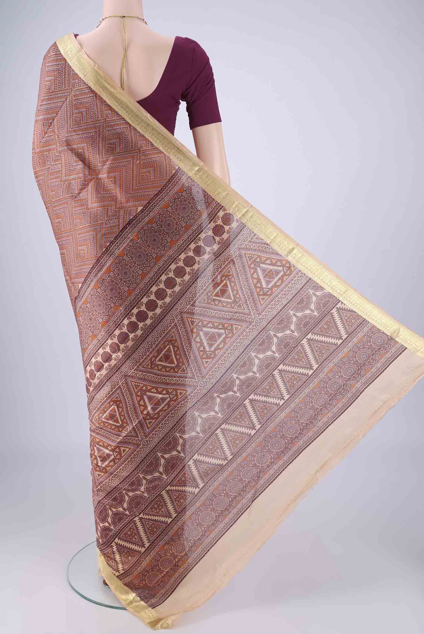Flat view of Brown Printed Silk Saree with Printed design on the body and Zari Border. 