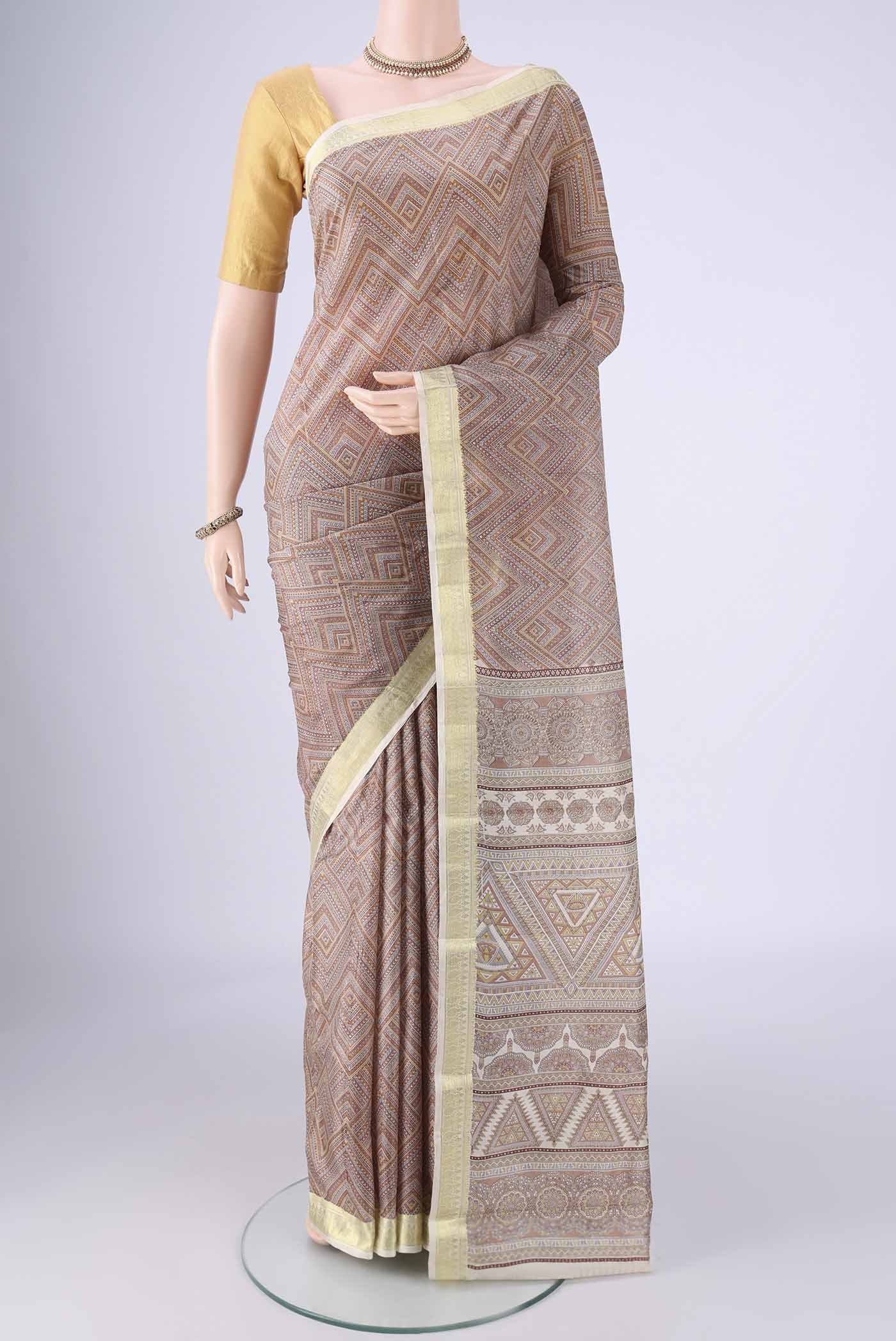 Brown Printed Silk Saree with Printed design on the body and Zari Border.  displayed on a mannequin
