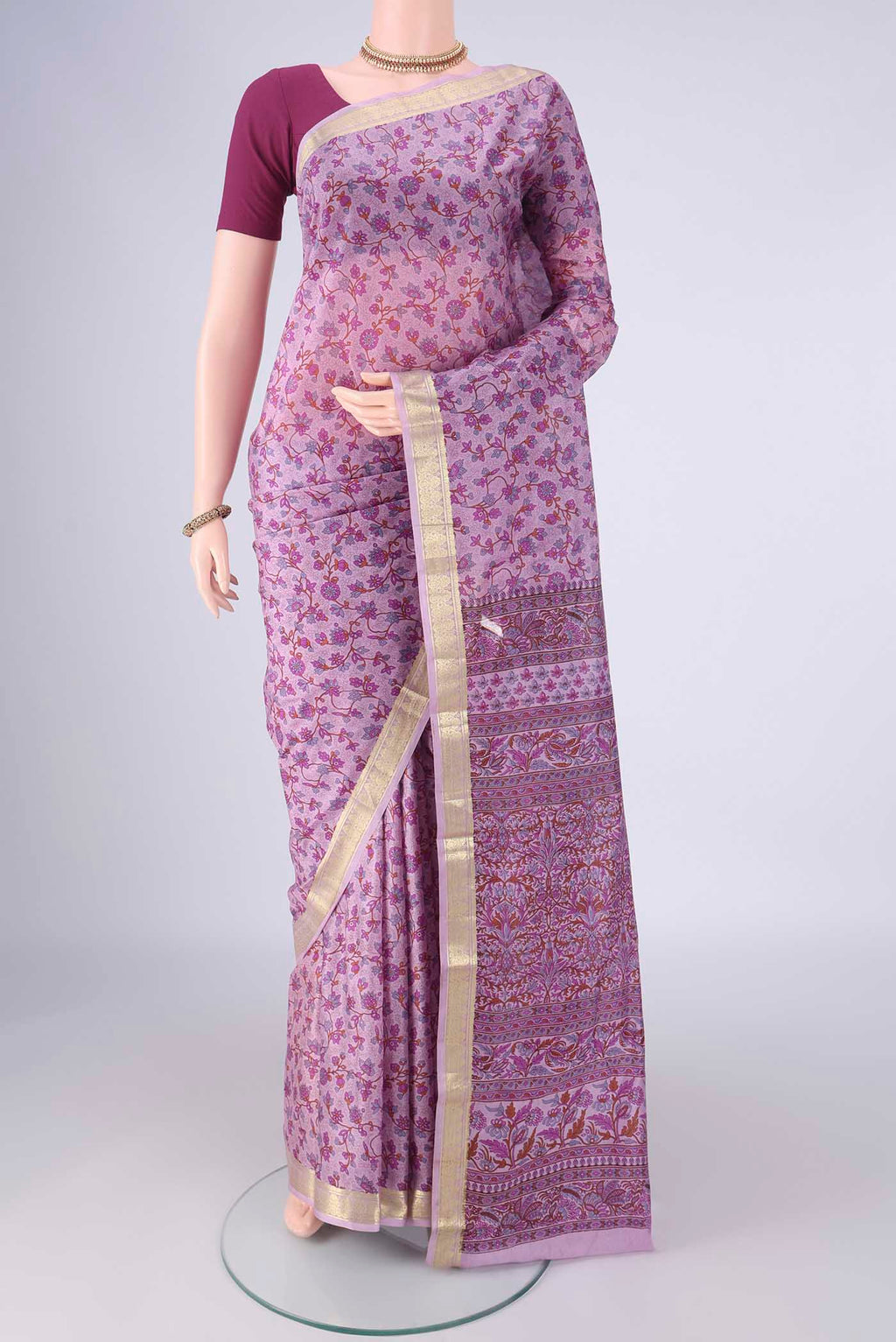 Lavender Printed Silk Saree with Printed design on the body and Zari Border.  displayed on a mannequin