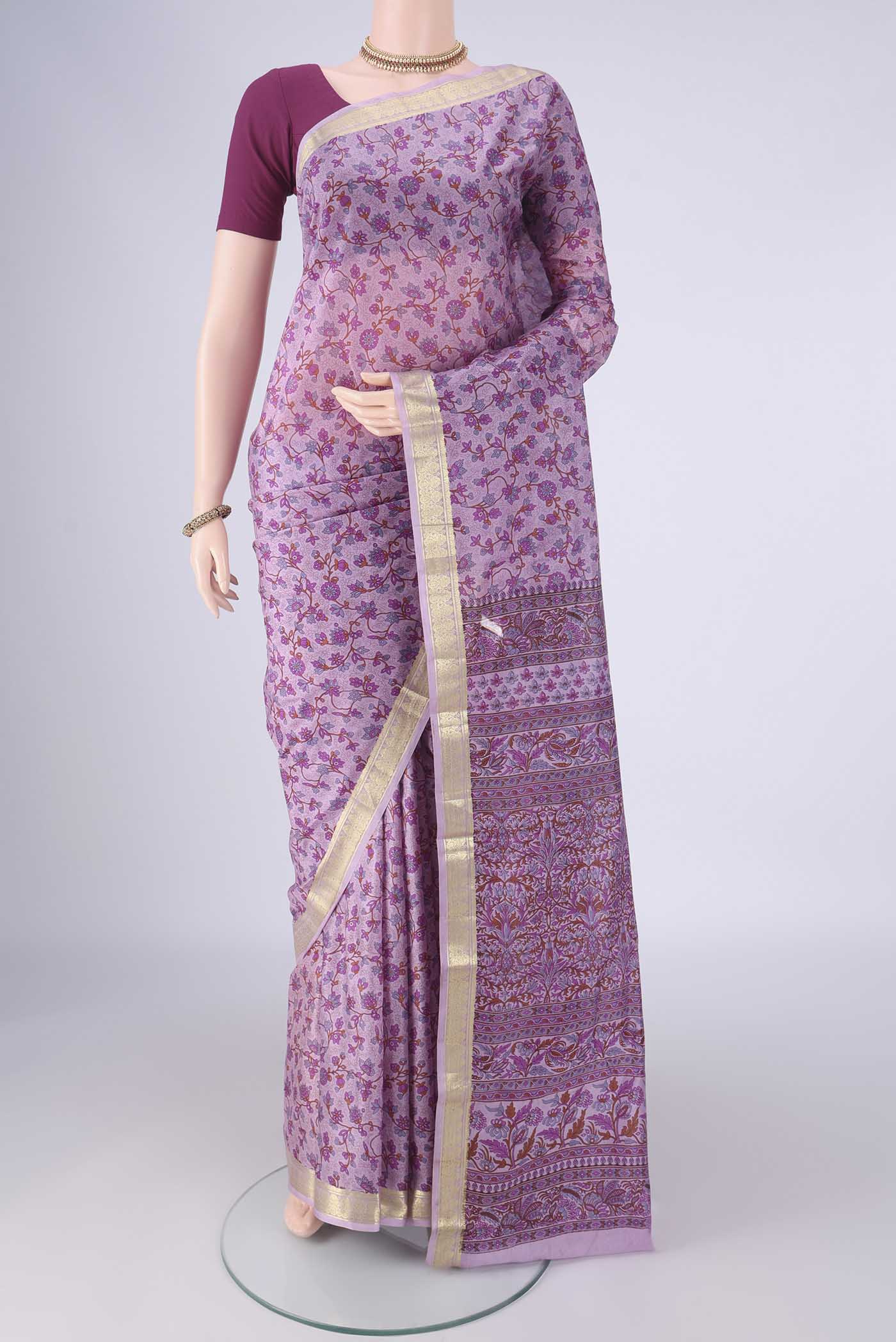 Lavender Printed Silk Saree with Printed design on the body and Zari Border.  displayed on a mannequin
