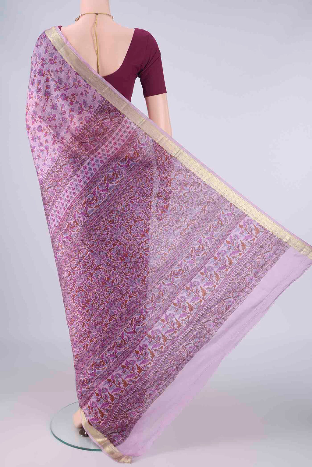 Flat view of Lavender Printed Silk Saree with Printed design on the body and Zari Border. 