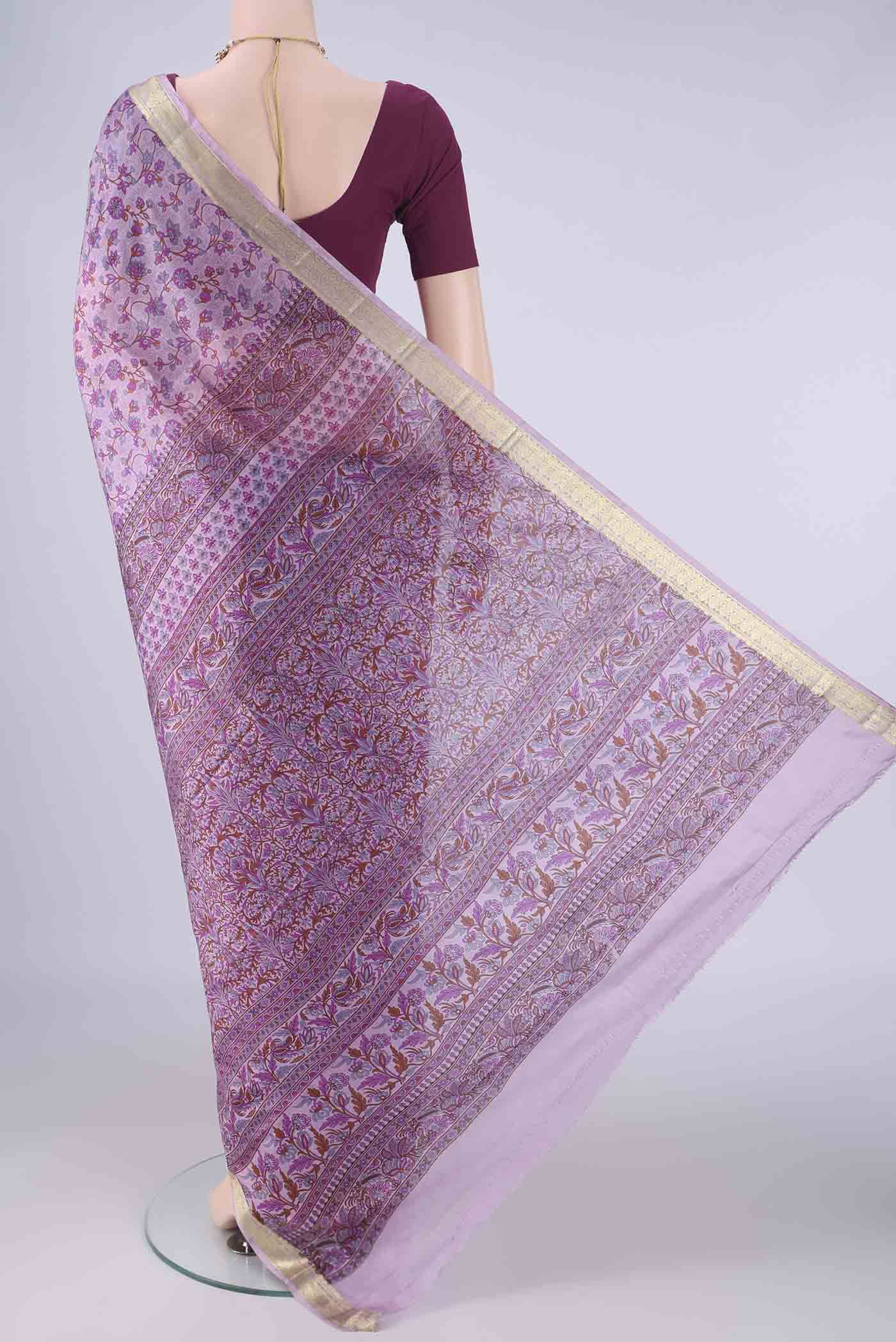 Flat view of Lavender Printed Silk Saree with Printed design on the body and Zari Border. 