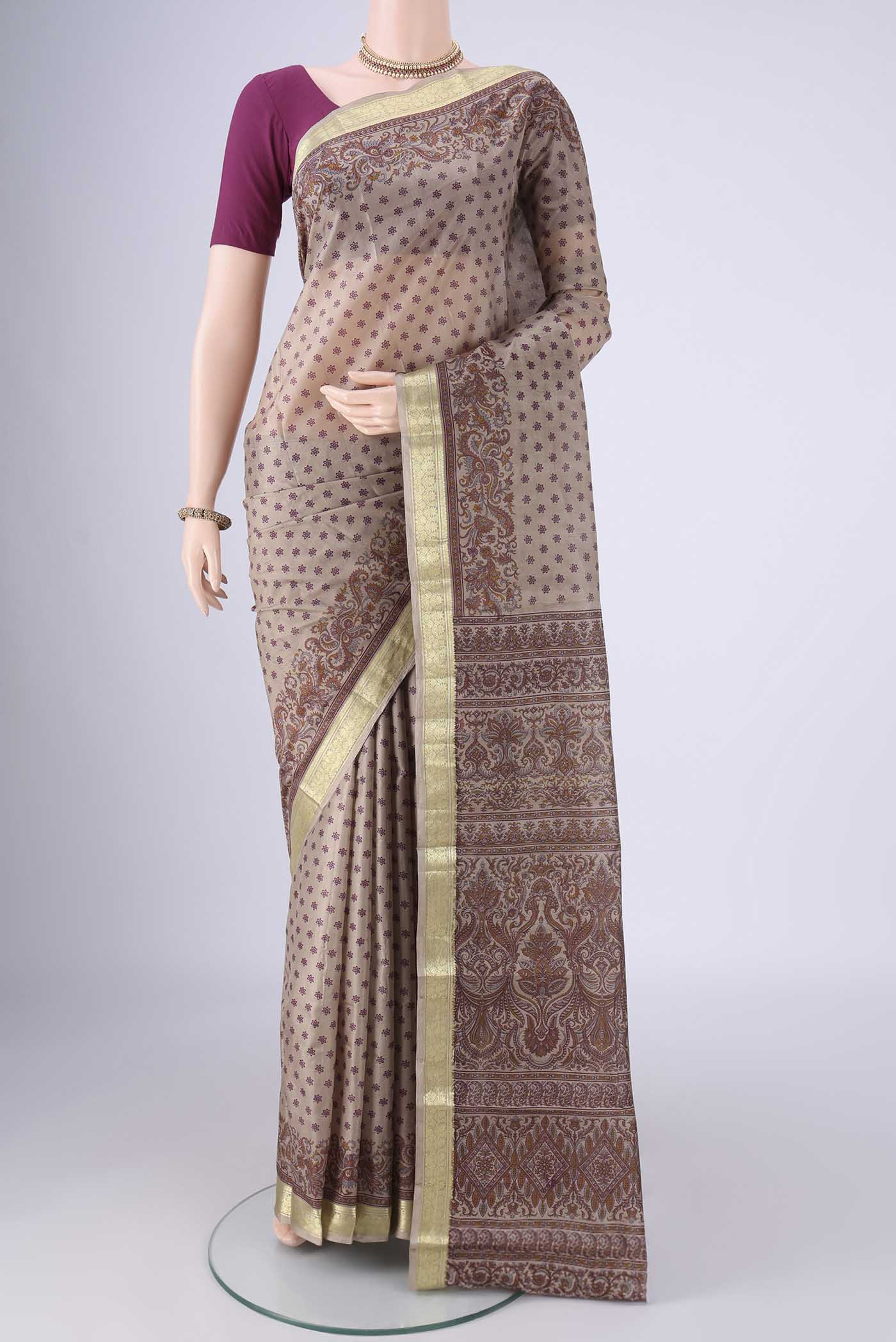 Dark Beige Printed Silk Saree with Printed design on the body and Zari Border.  displayed on a mannequin