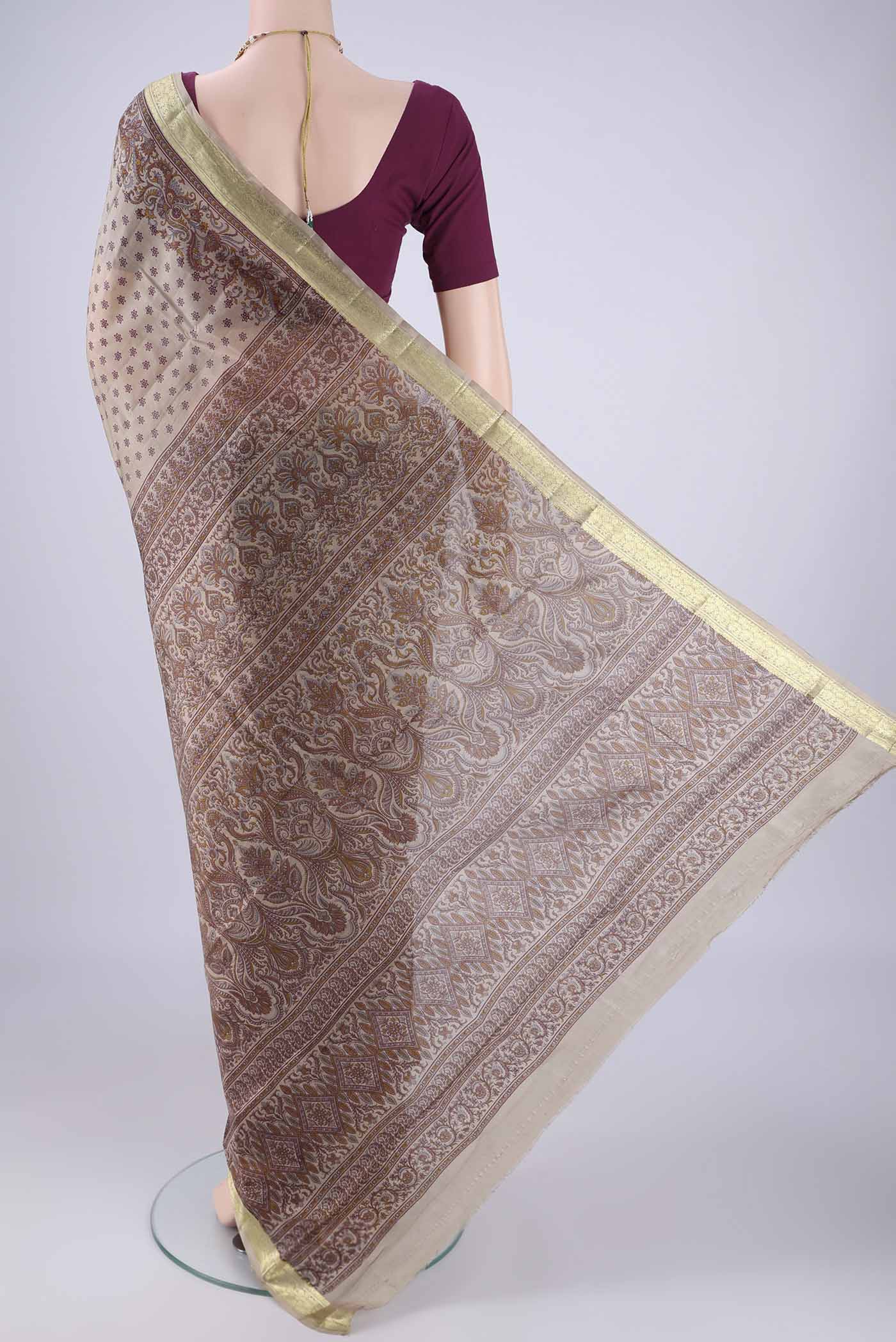 Flat view of Dark Beige Printed Silk Saree with Printed design on the body and Zari Border. 