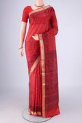 Red Printed Silk Saree with Printed design on the body and Zari Border.  displayed on a mannequin