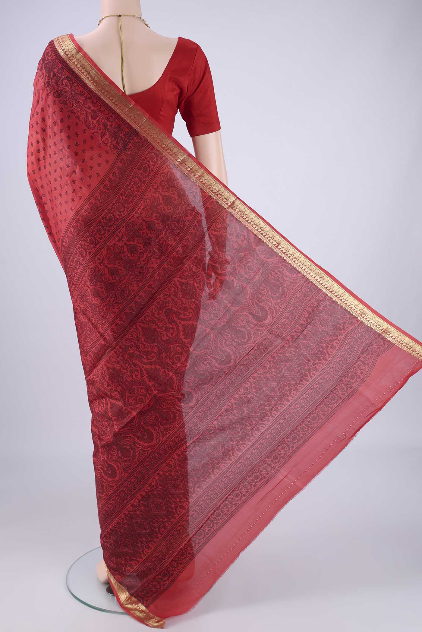 Flat view of Red Printed Silk Saree with Printed design on the body and Zari Border. 