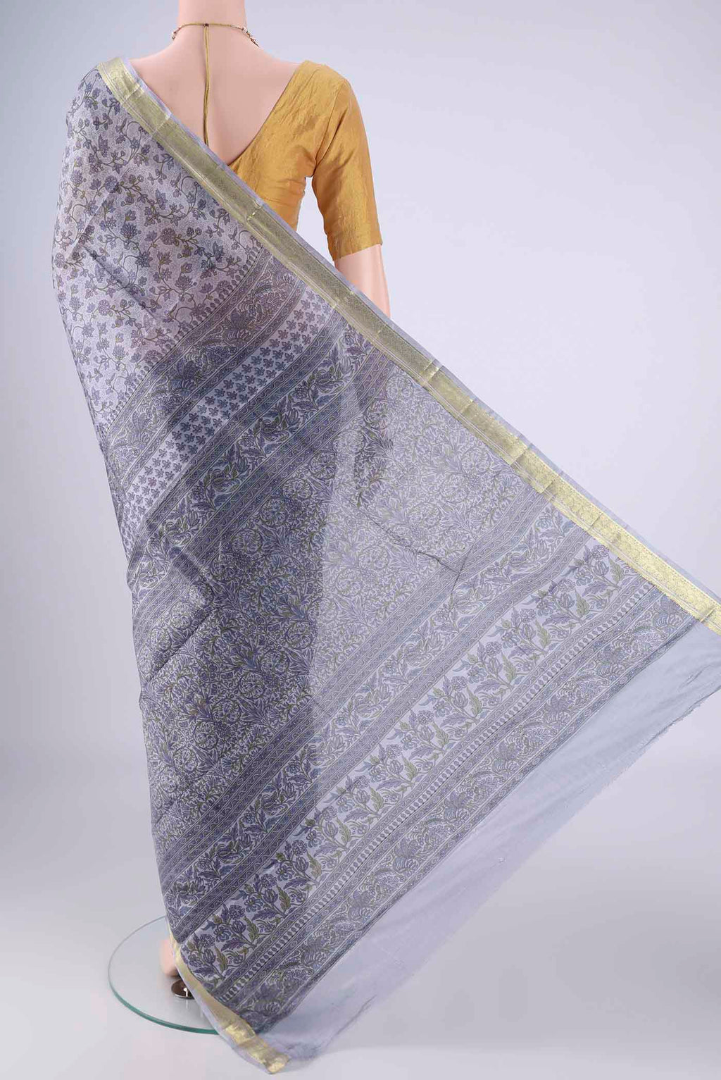 Flat view of Grey Printed Silk Saree with Printed design on the body and Zari Border. 