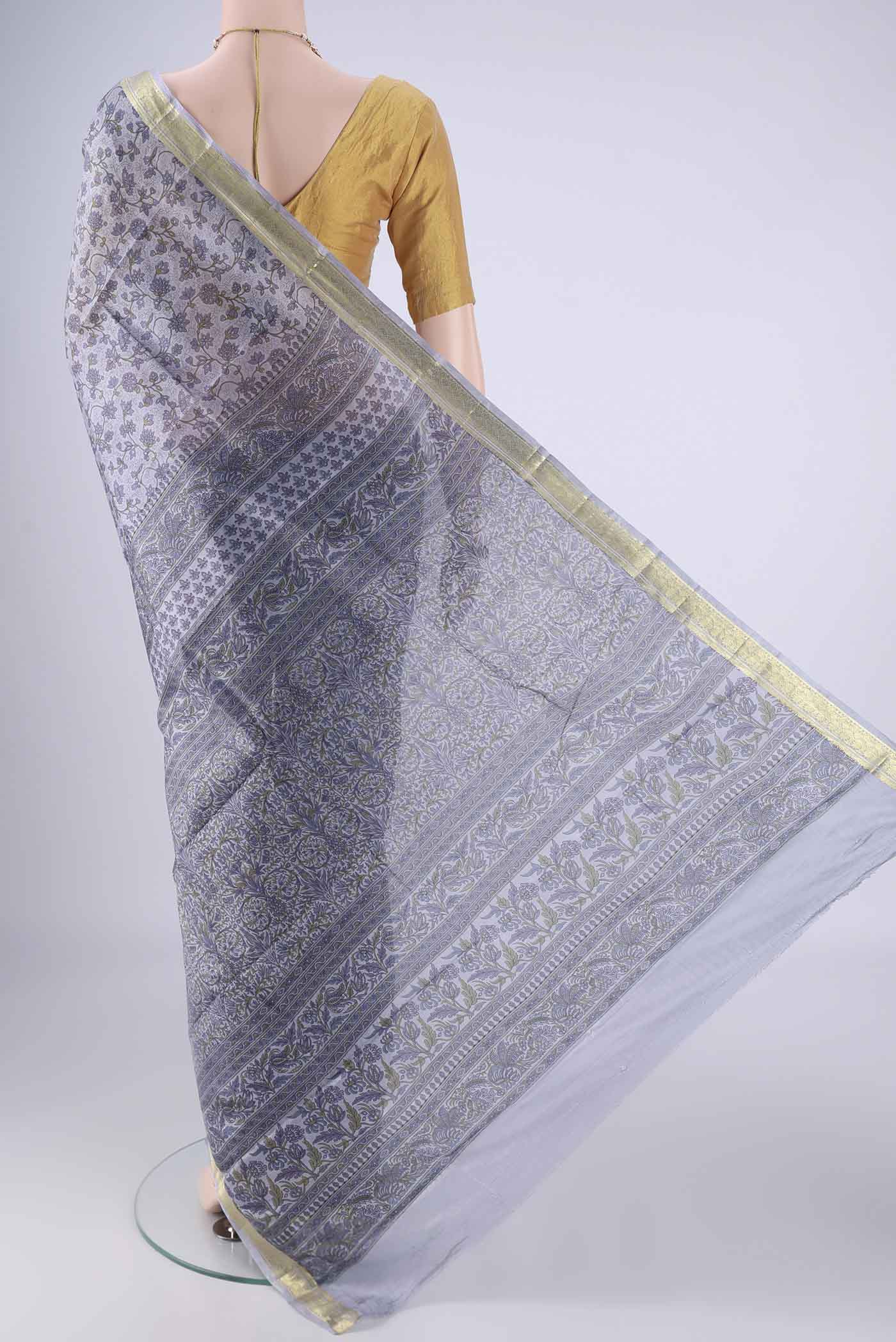 Flat view of Grey Printed Silk Saree with Printed design on the body and Zari Border. 
