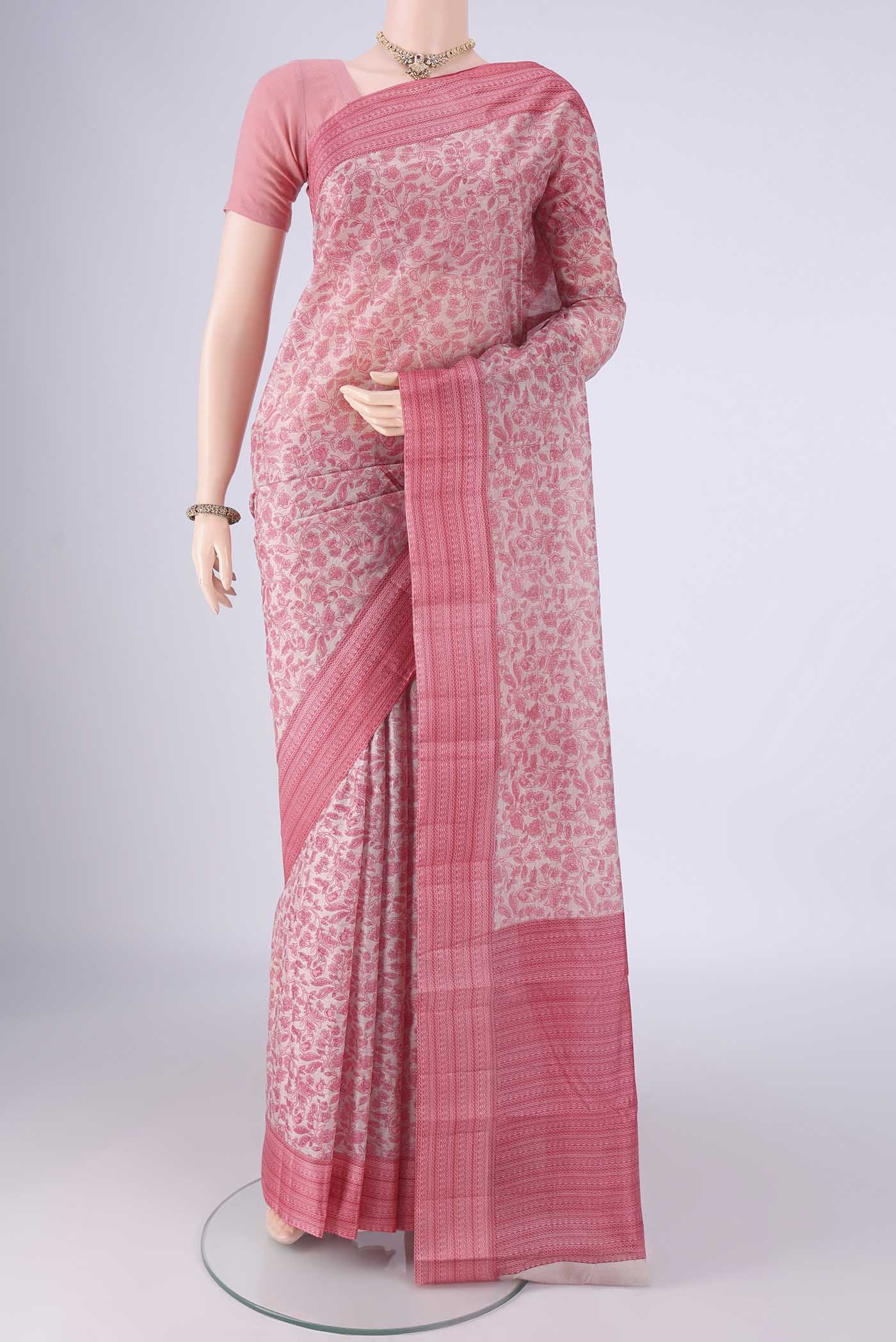 Rose pink Printed Silk Saree with Printed design on the body and Printed Border.  displayed on a mannequin
