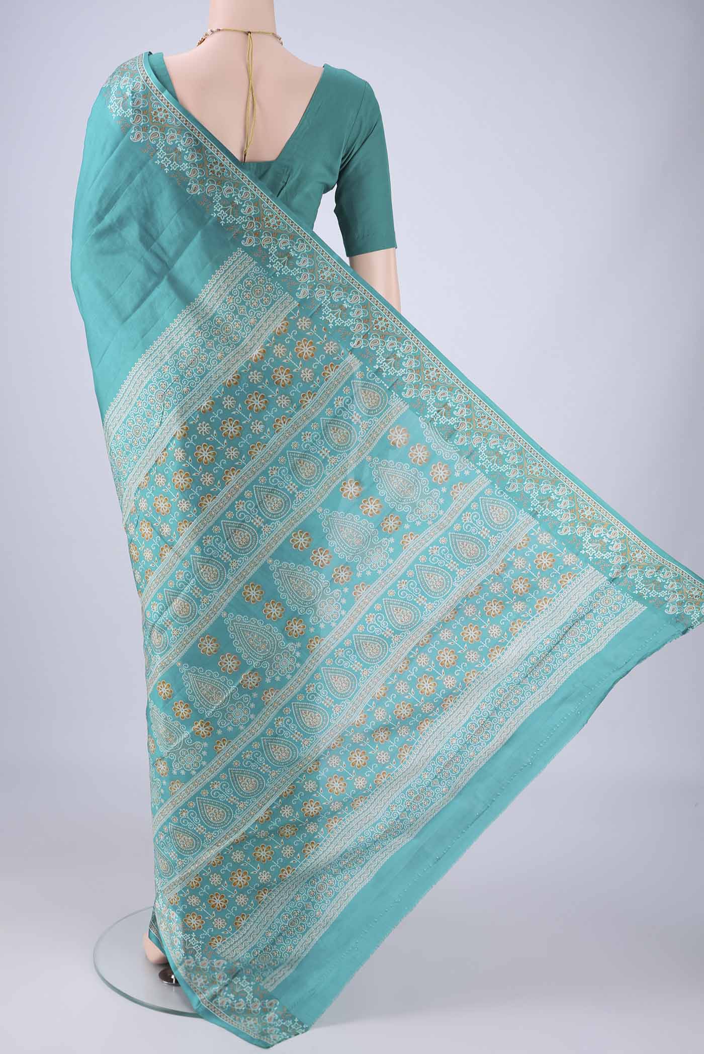 Flat view of Turquoise Printed Silk Saree with Plain Body and Printed Border. 