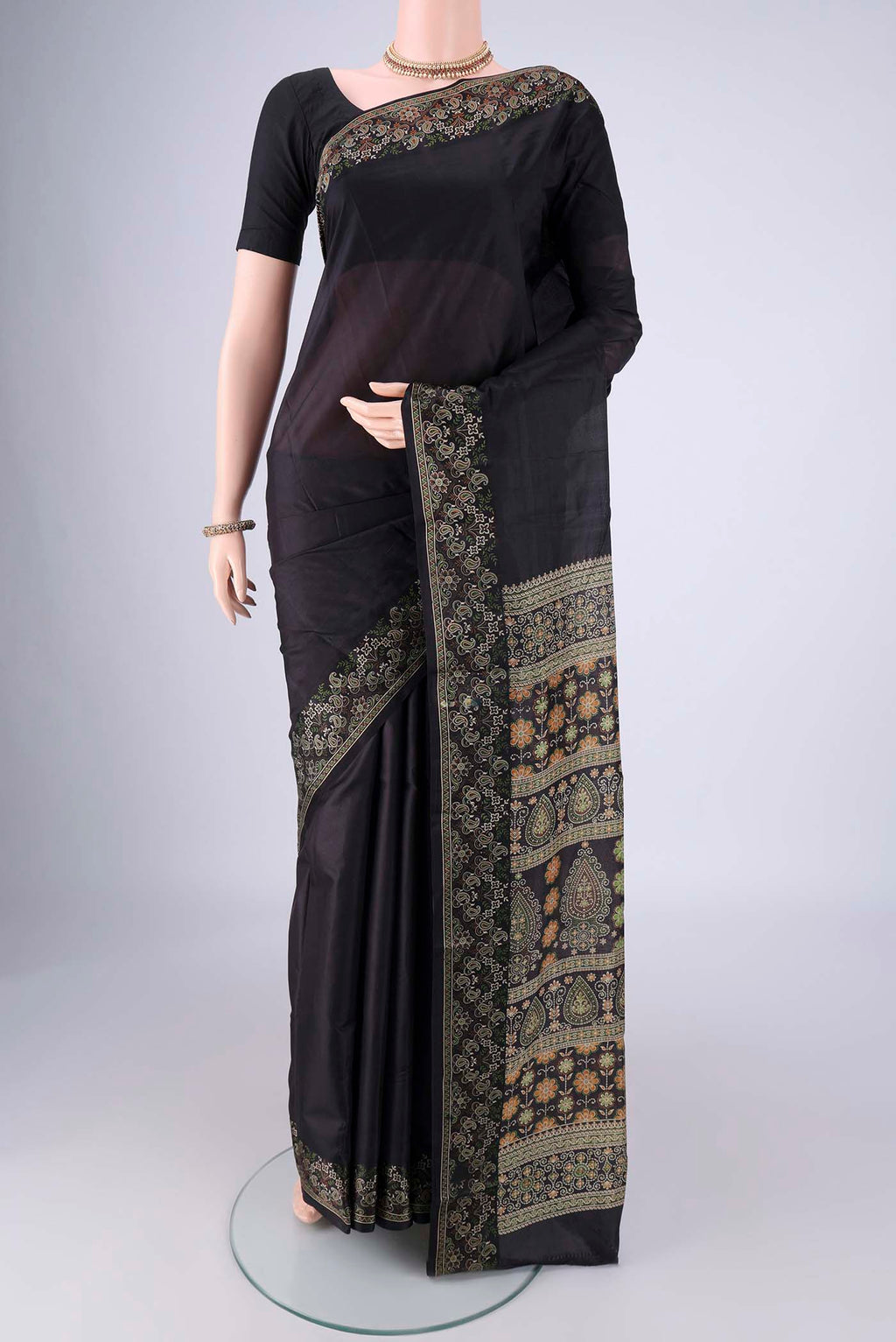 Black Printed Silk Saree with Plain Body and Printed Border.  displayed on a mannequin