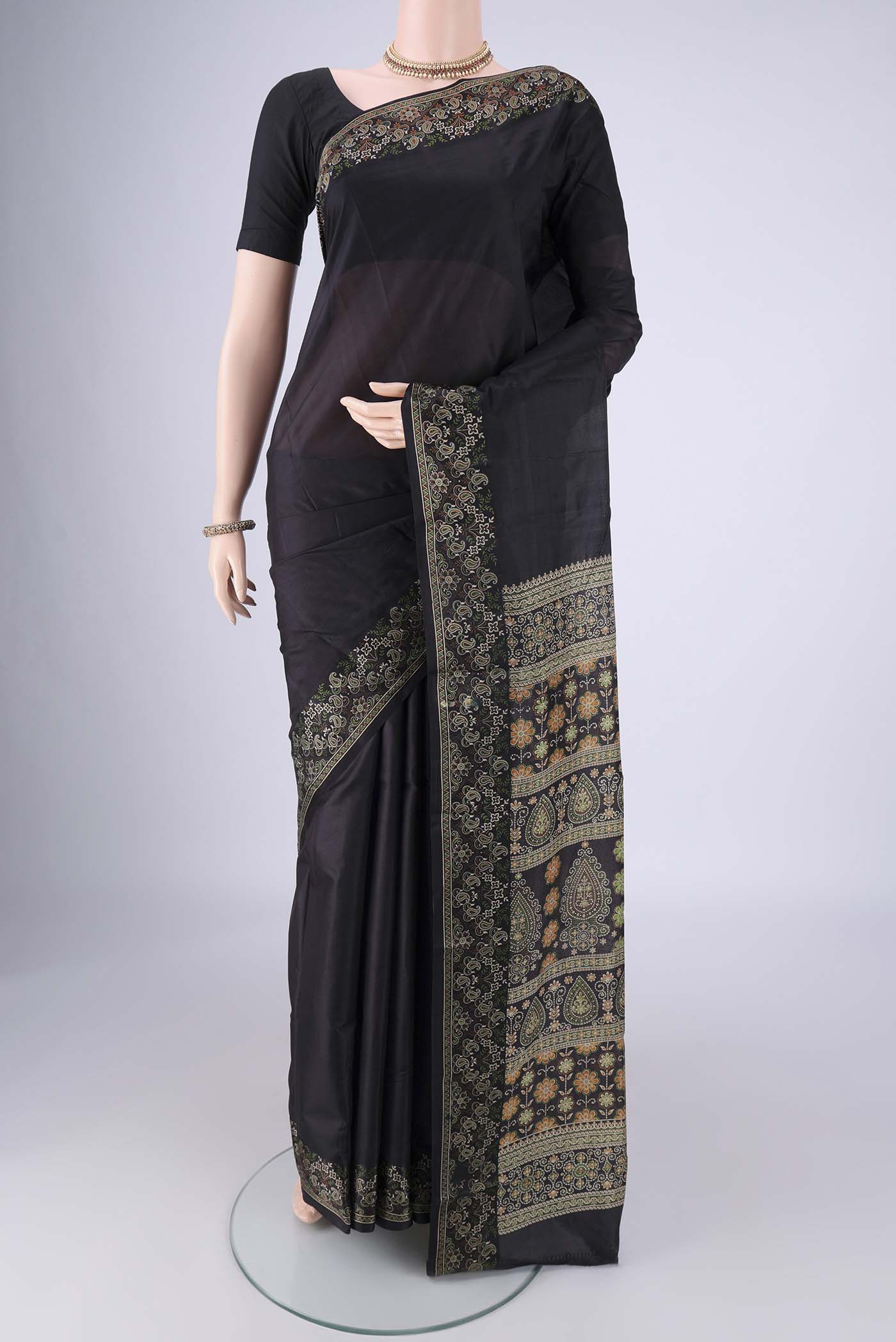 Black Printed Silk Saree with Plain Body and Printed Border.  displayed on a mannequin