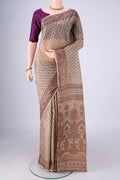 Beige Printed Silk Saree with Printed design on the body and Printed Border.  displayed on a mannequin