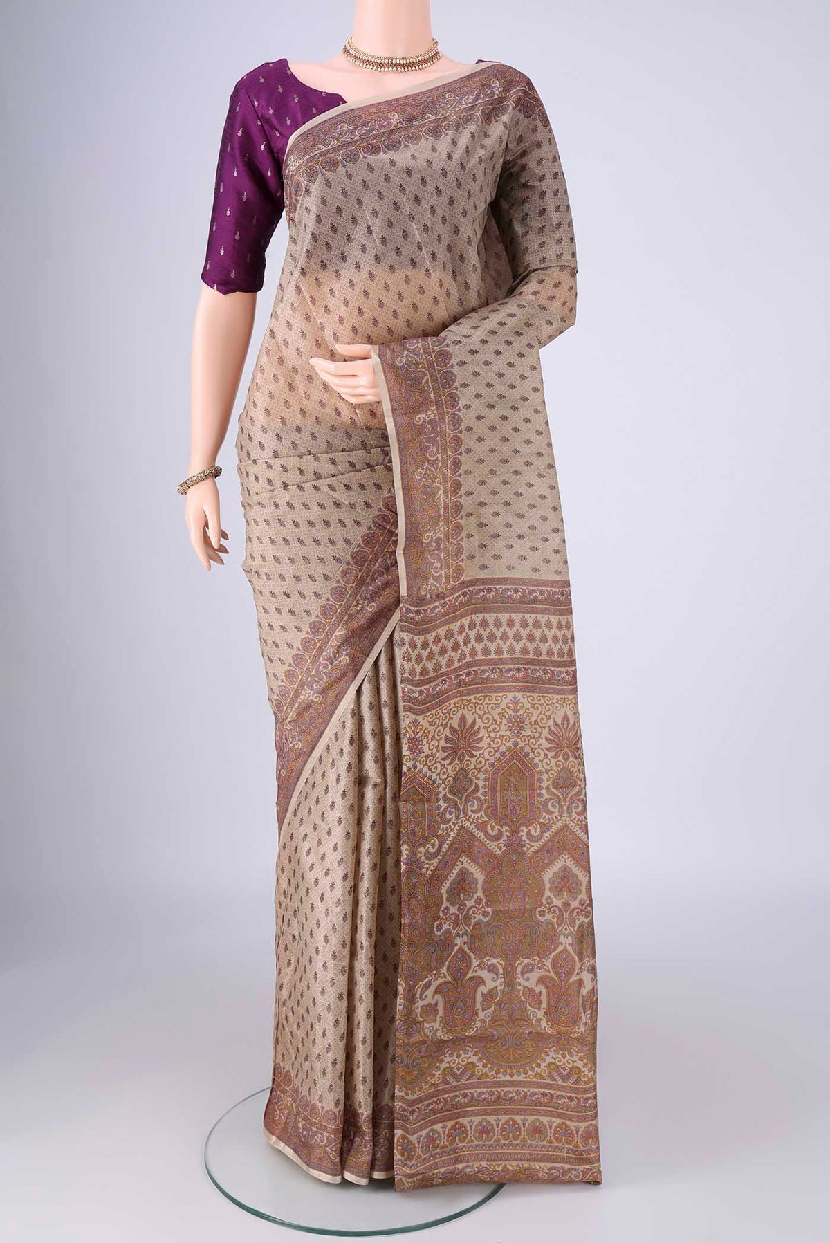 Beige Printed Silk Saree with Printed design on the body and Printed Border.  displayed on a mannequin