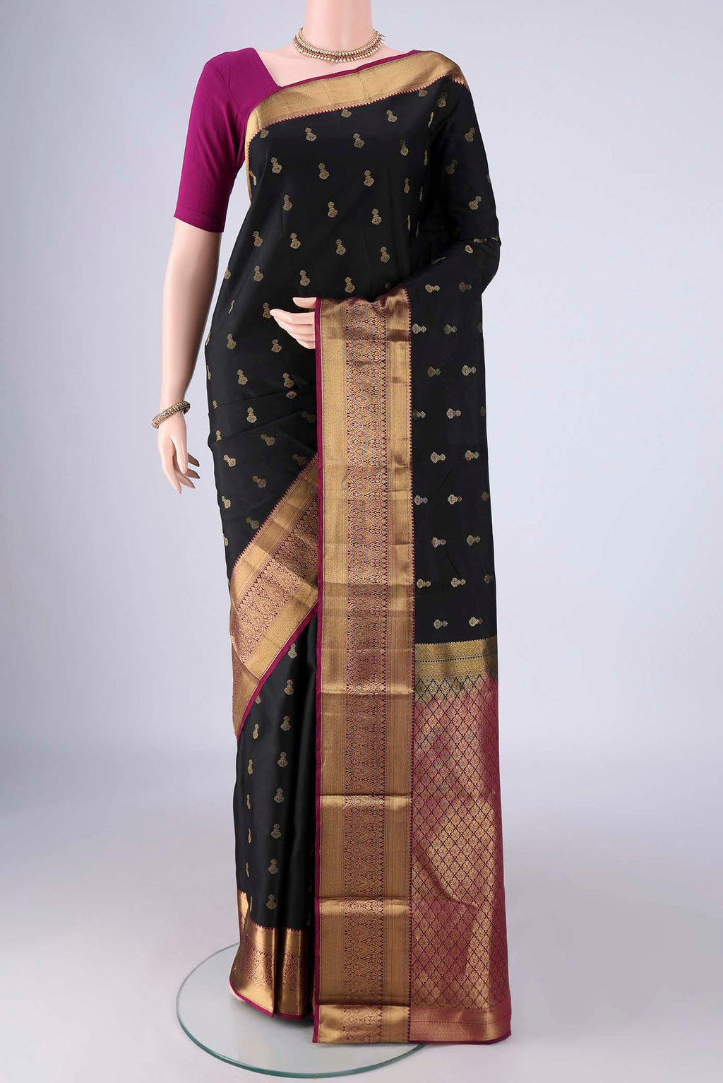 Black Kanjivaram Silk Saree with Zari Butta on the body and Zari Border.  displayed on a mannequin
