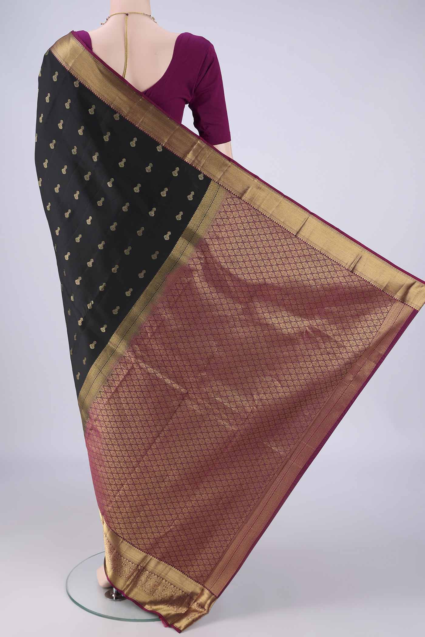 Flat view of Black Kanjivaram Silk Saree with Zari Butta on the body and Zari Border. 