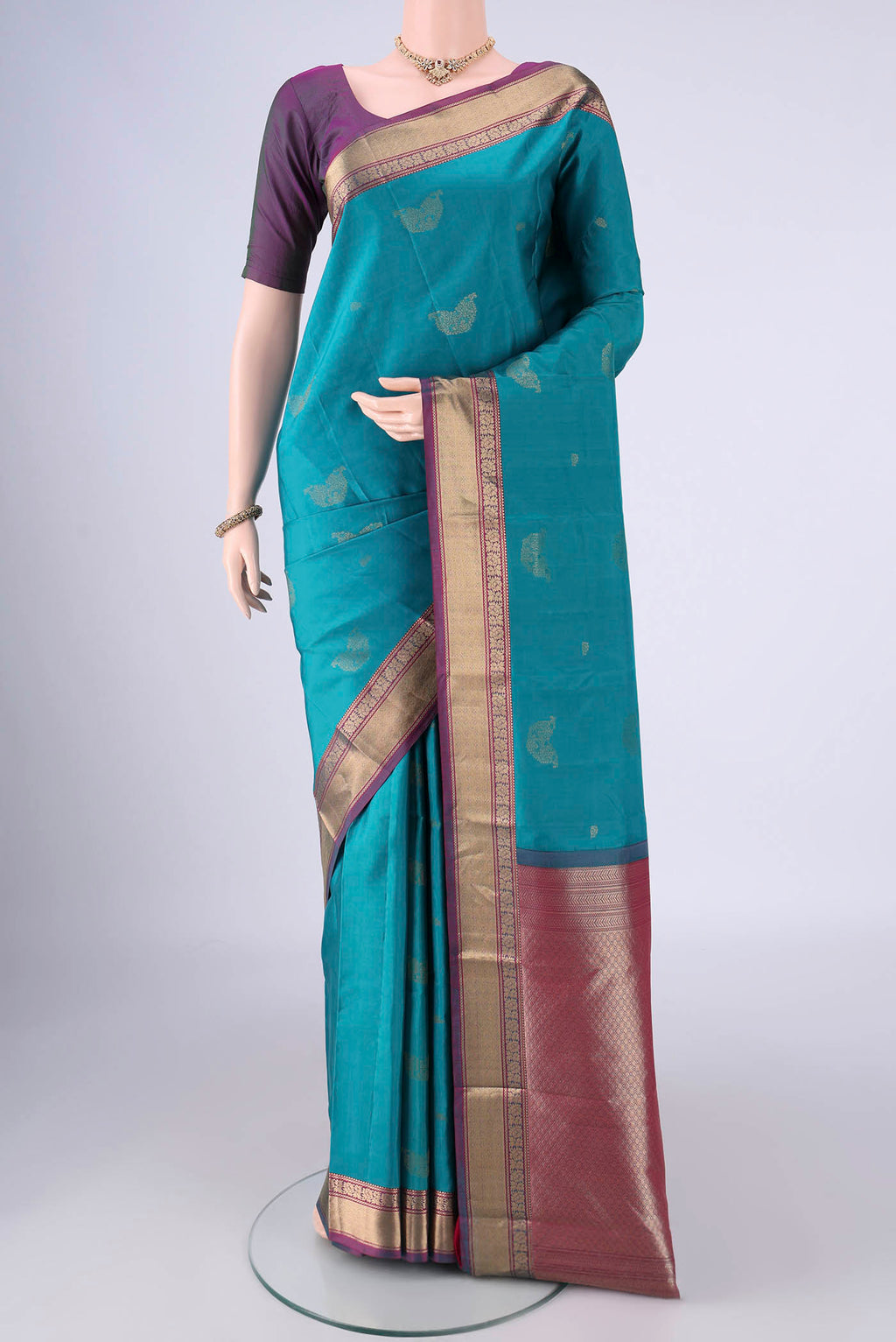 Sea Green Nangavalli Silk [ Salem ] Saree with Zari Butta on the body and Zari Border.  displayed on a mannequin