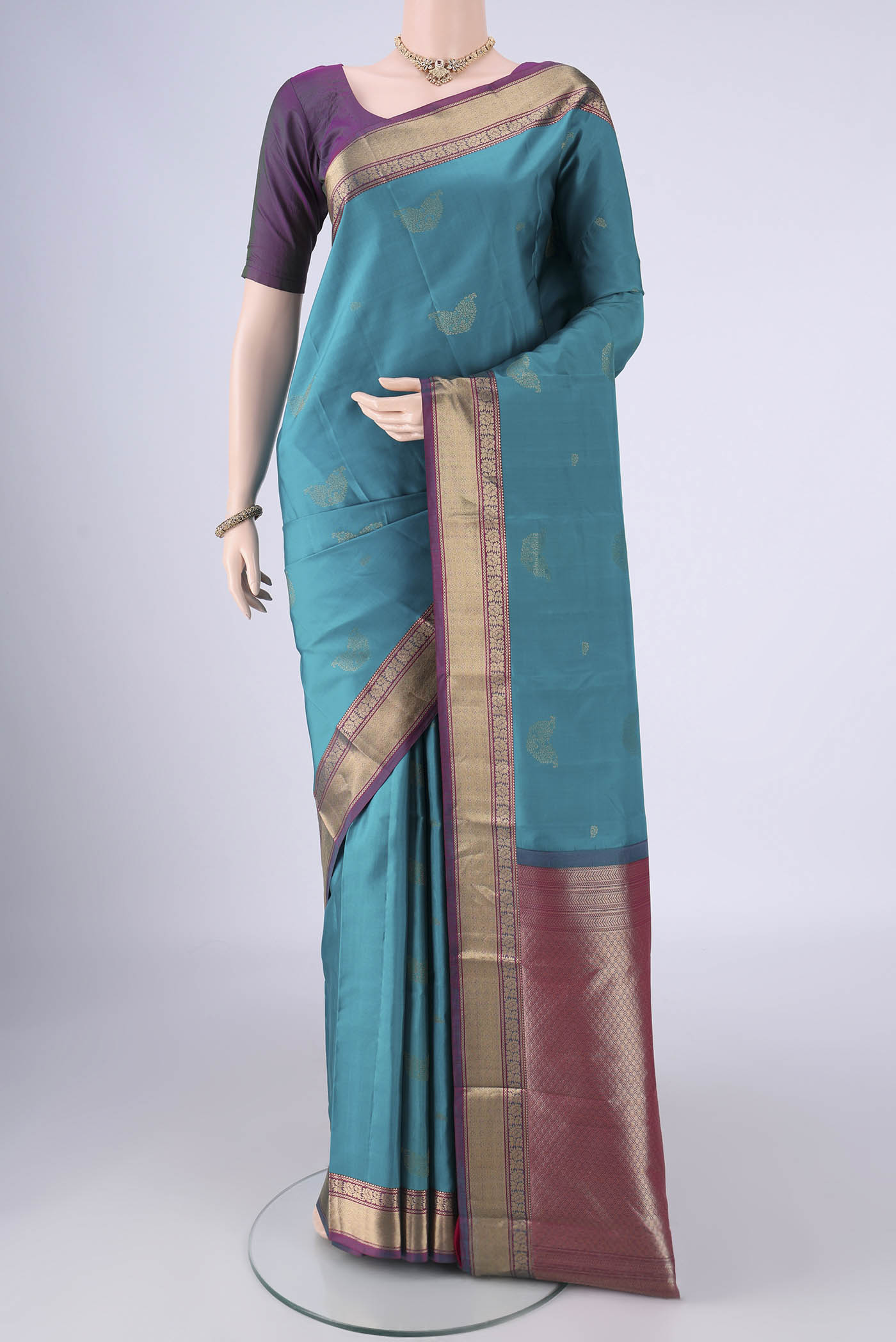 Sea Green Nangavalli Silk [ Salem ] Saree with Zari Butta on the body and Zari Border.  displayed on a mannequin