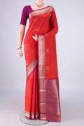 Orange Kanchipuram Silk Saree with Zari Butta on the body and Zari Border.  displayed on a mannequin