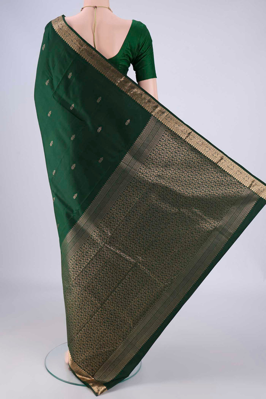 Flat view of Bottle Green Kanjivaram Silk Saree with Zari Butta on the body and Zari Border. 