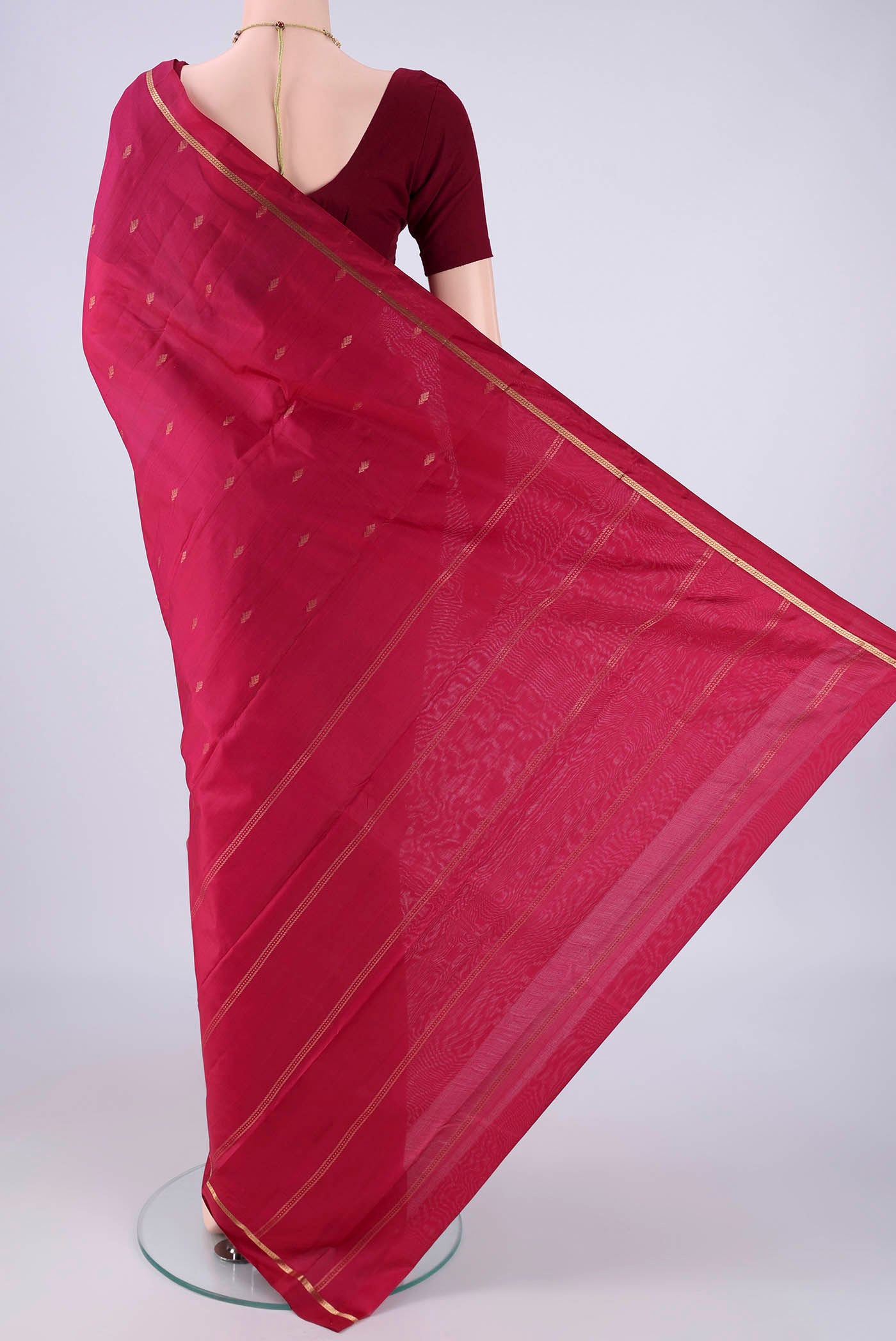 Flat view of Maroon Kanjivaram Silk Saree with Zari Butta on the body and Zari Border. 